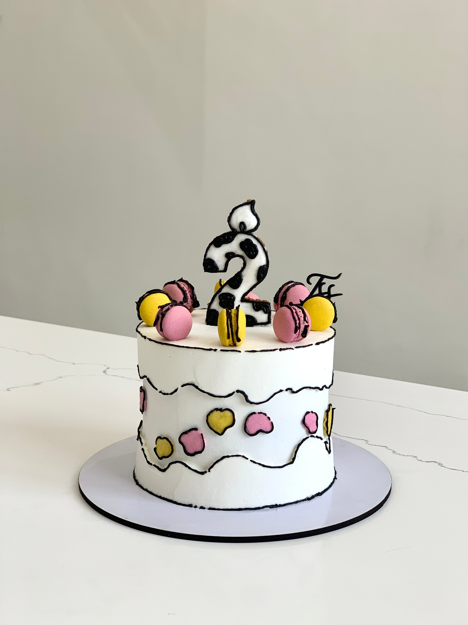 Colorful comic cake decorated with vibrant icing and fun cartoon-themed designs by The Sinful Spoon.