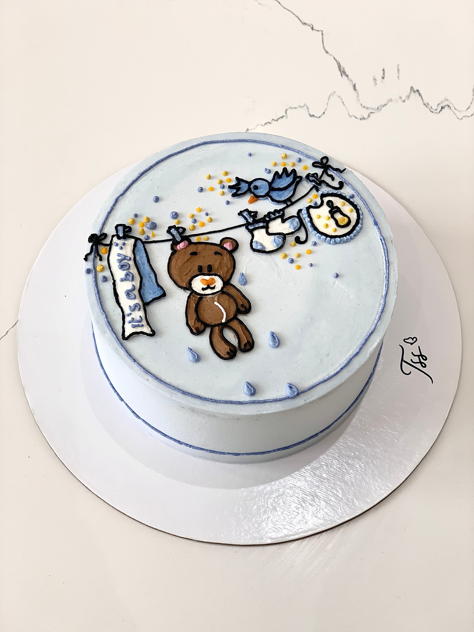 Decorative baby shower cake with pastel colors and themed decorations by The Sinful Spoon, perfect for celebrating new arrivals.