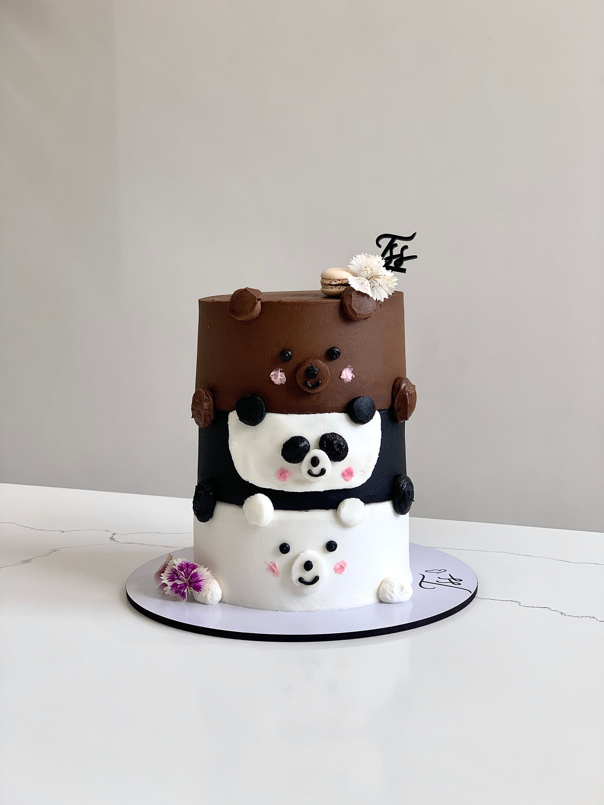 Decorative baby shower cake with pastel colors and cute baby-themed fondant accents from The Sinful Spoon.