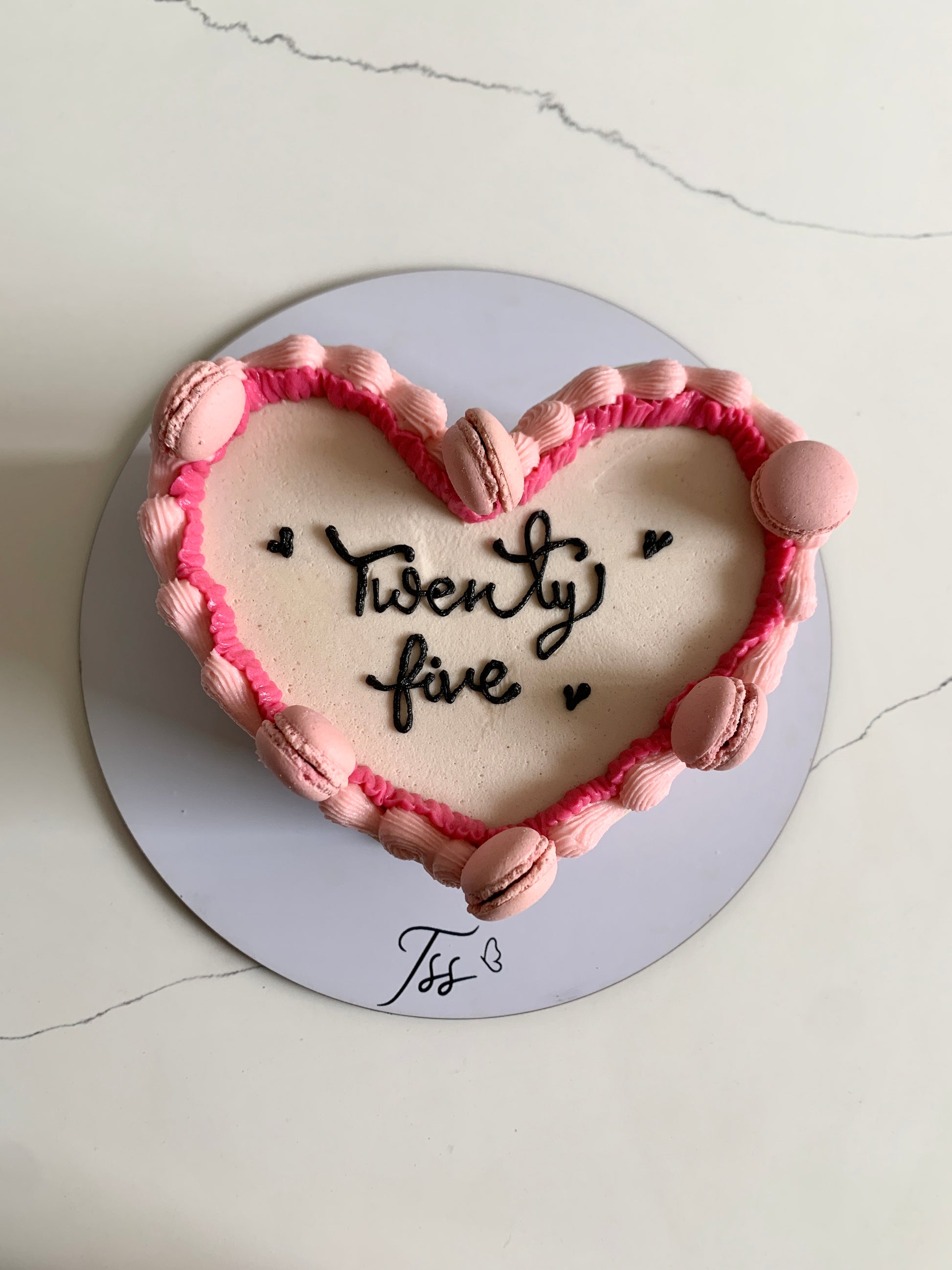 Heart shaped cakes from The Sinful Spoon with smooth frosting and decorative toppings, perfect for special occasions.