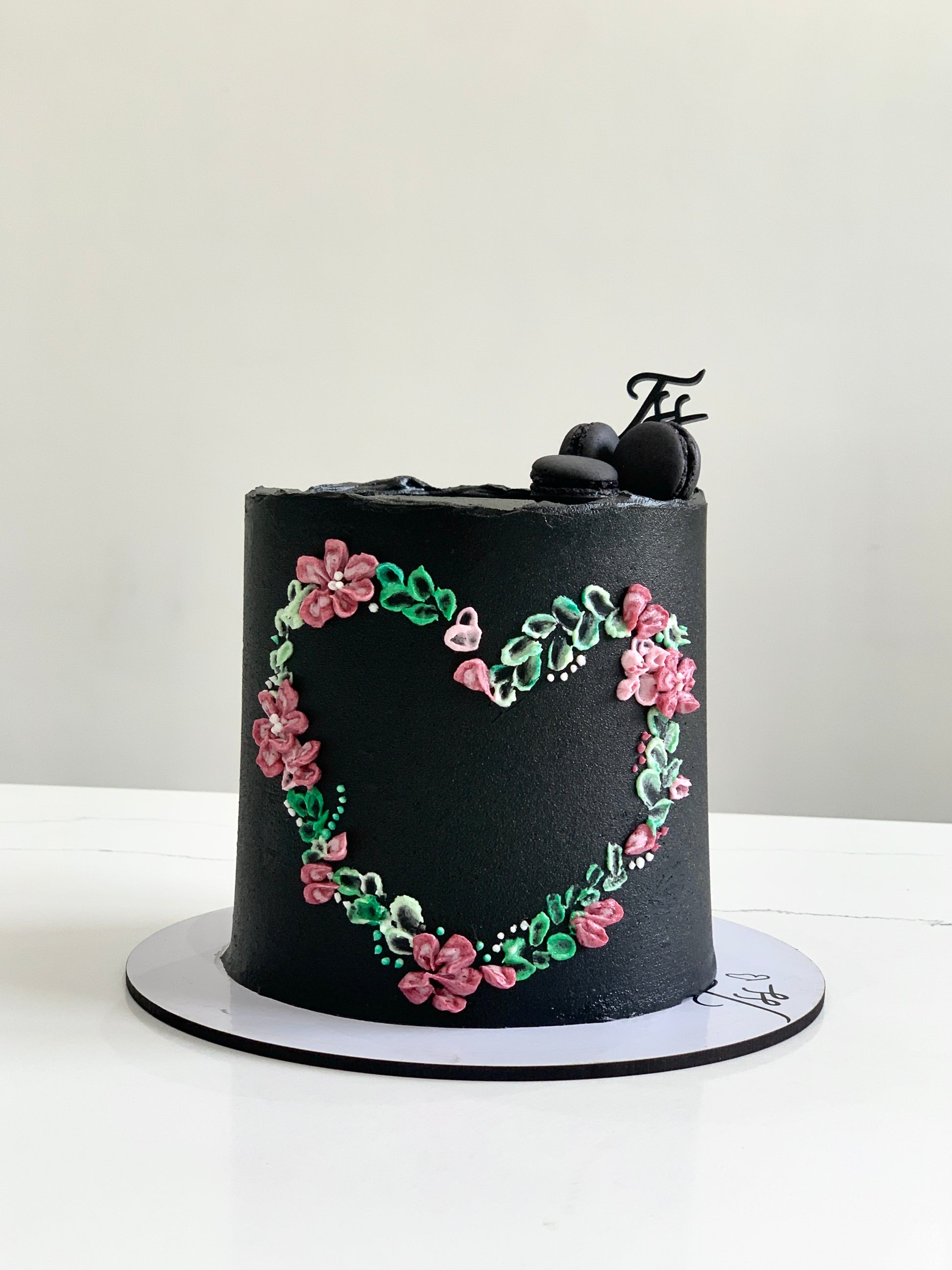 Valentine's Day cakes from The Sinful Spoon featuring heart-shaped designs and festive decorations on a decorative cake display.