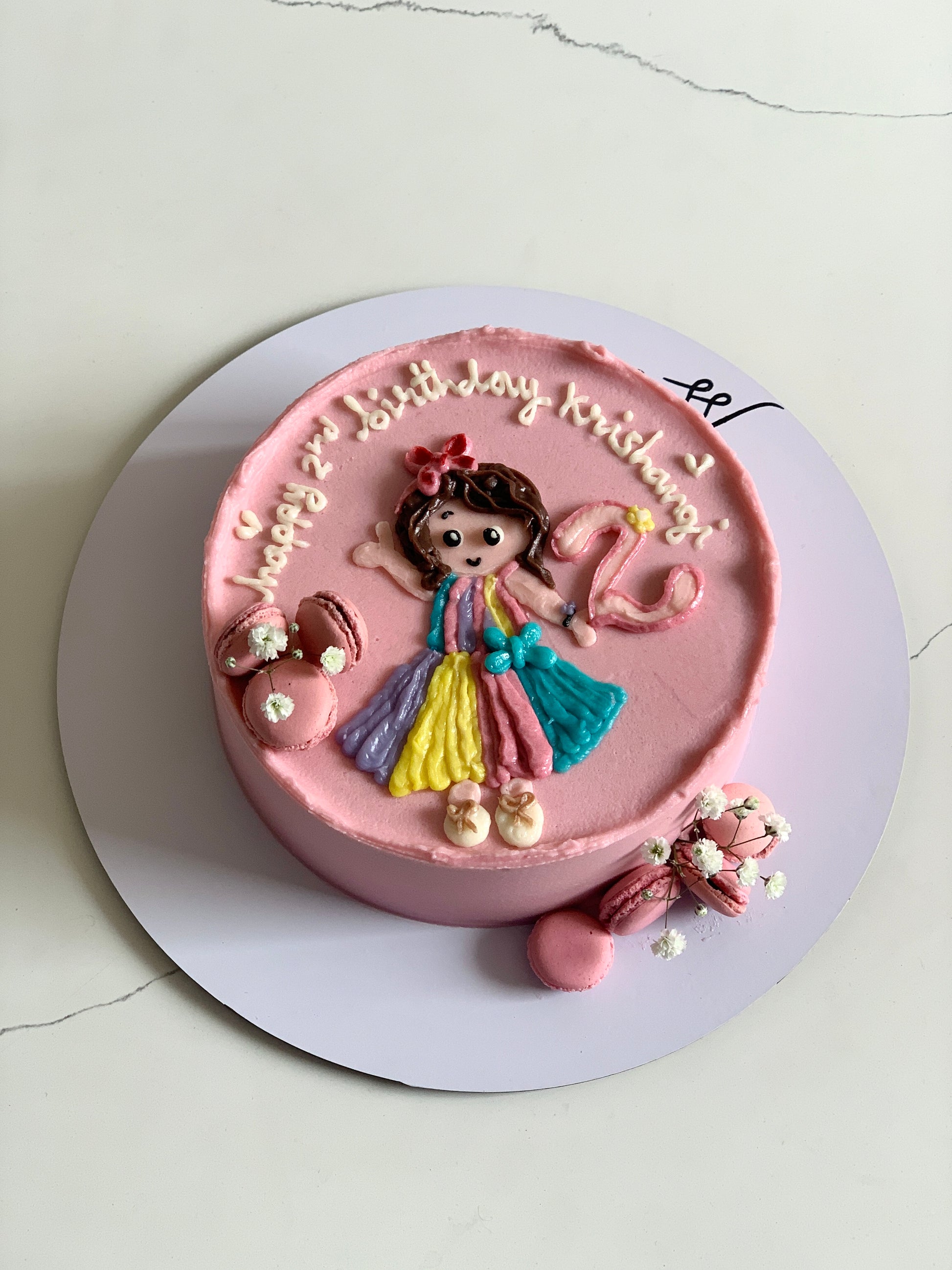 Decorative buttercream illustration cake by The Sinful Spoon, showcasing colorful floral and whimsical piping designs.
