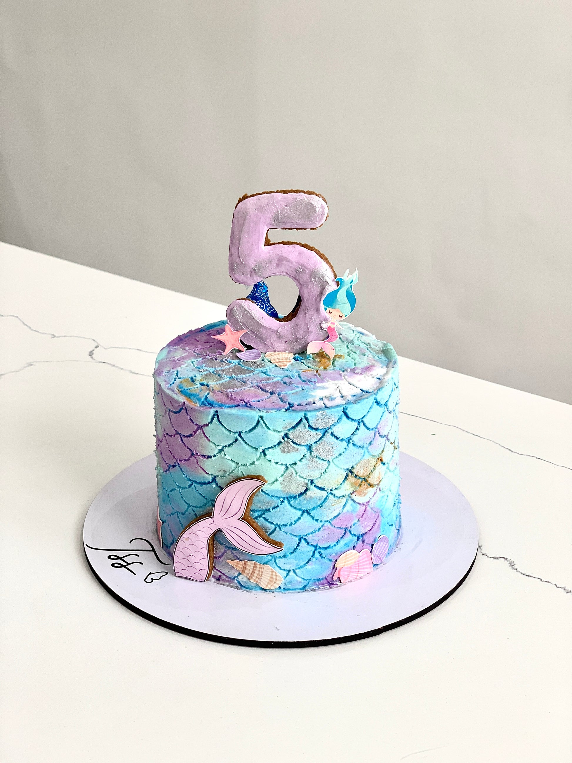 Edible paper cake topper featuring a baby girl design from The Sinful Spoon, ideal for baby shower cakes.