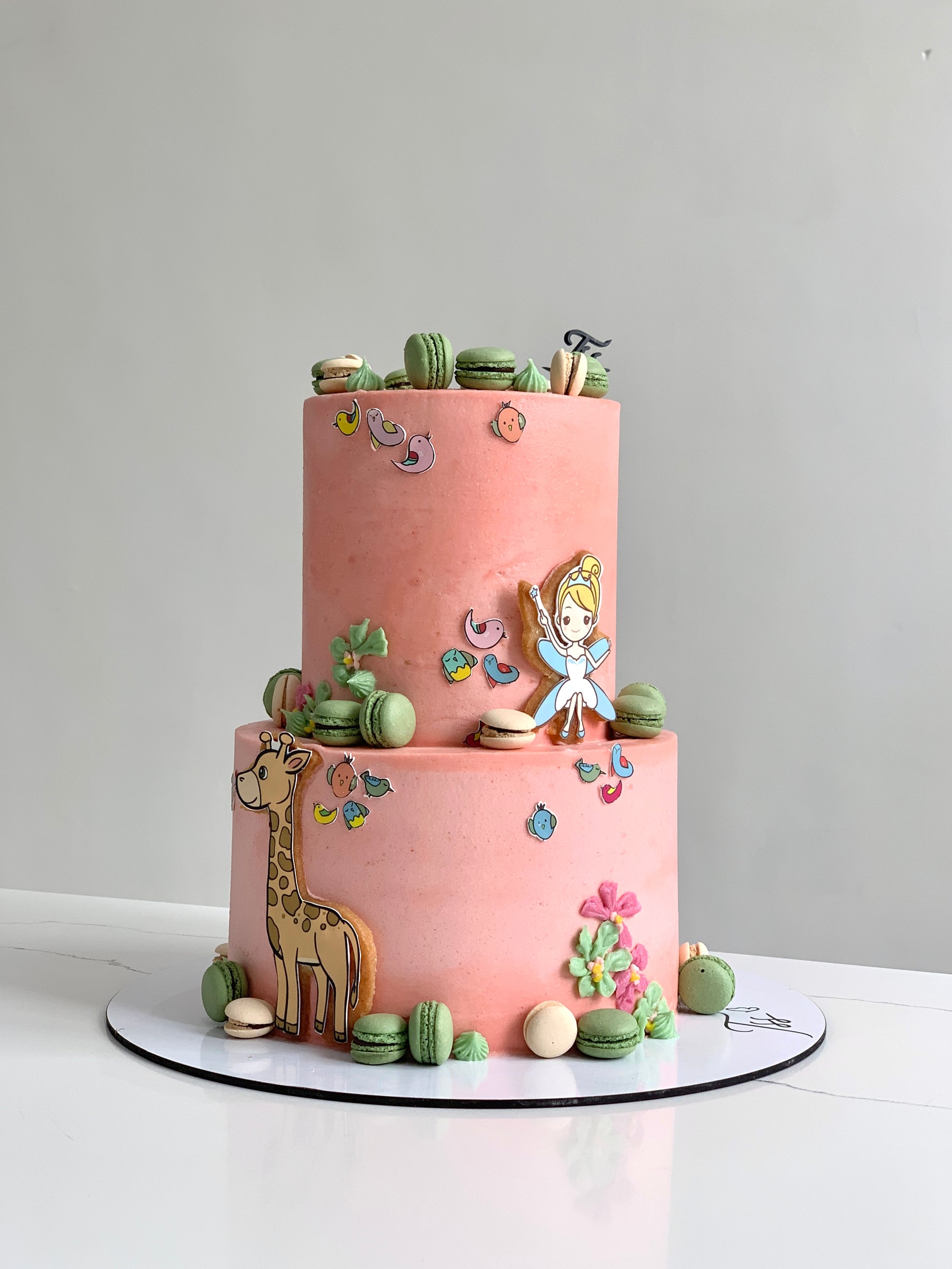 Colorful tiered kids cake from The Sinful Spoon, decorated with playful frosting and fun designs for children's celebrations.