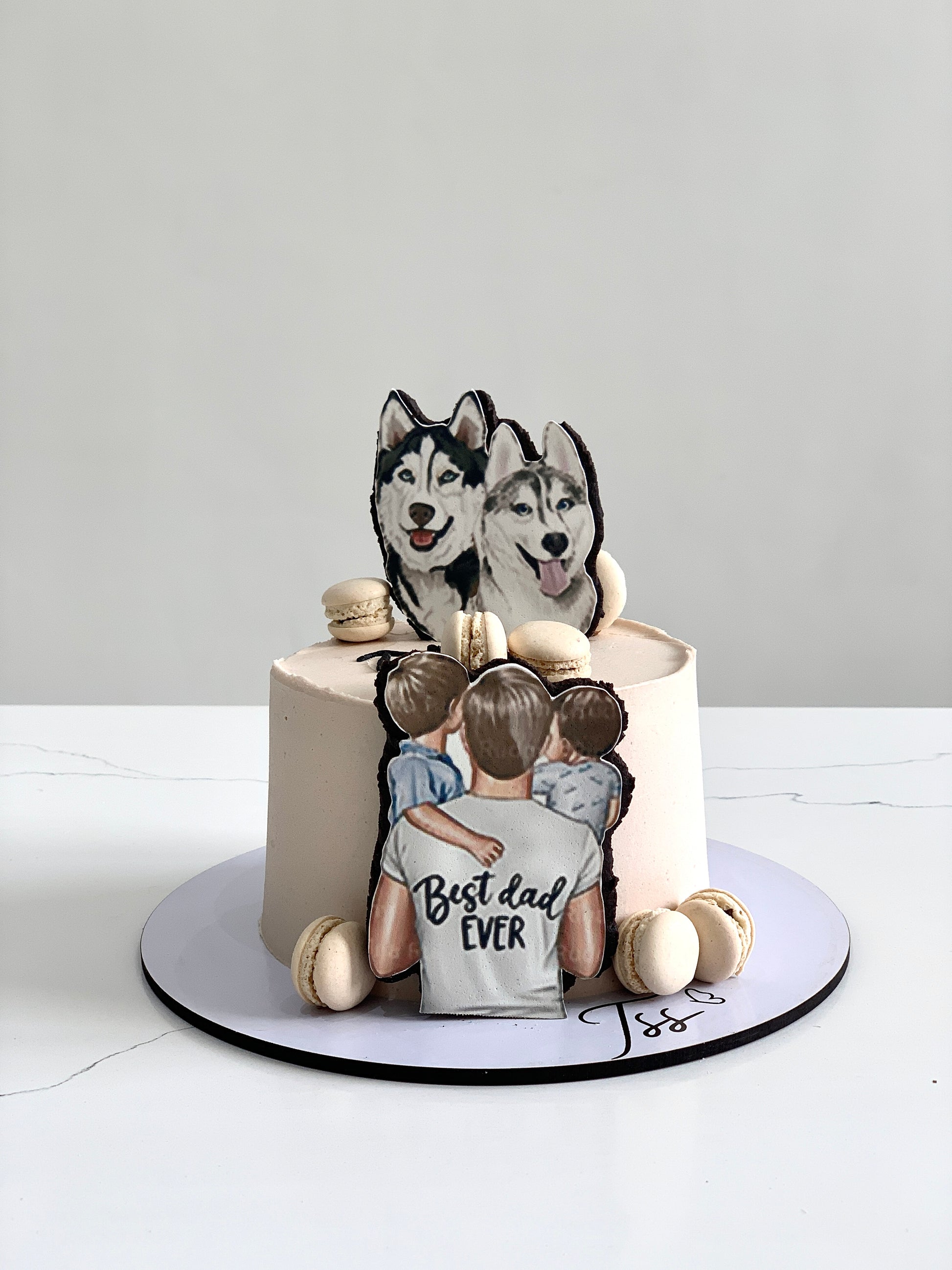 The Sinful Spoon Father's Day cake with chocolate frosting and decorative message on top, displayed on a serving plate.