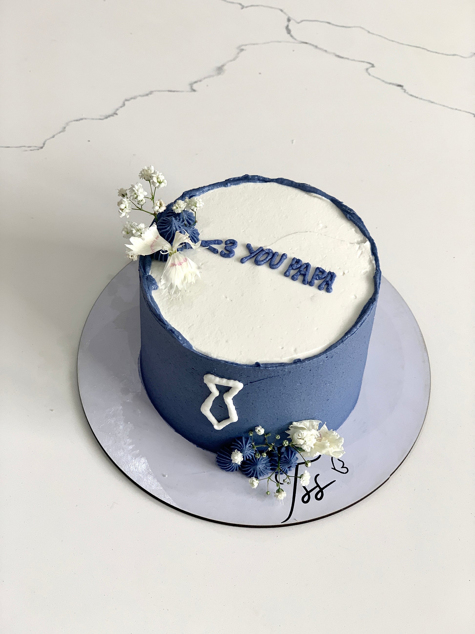 Decorative Father’s Day cake from The Sinful Spoon with colorful frosting and themed toppings.