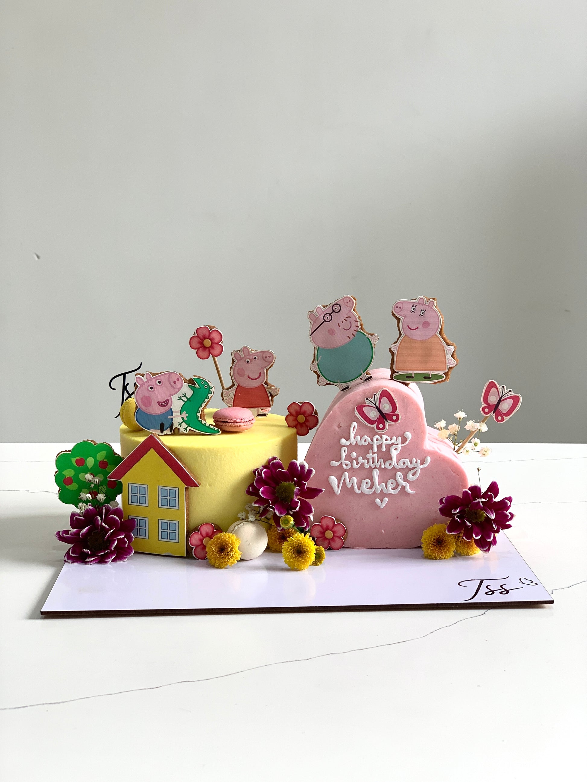 Heart-shaped cakes from The Sinful Spoon with vibrant pink frosting and decorative sprinkles on a white plate.