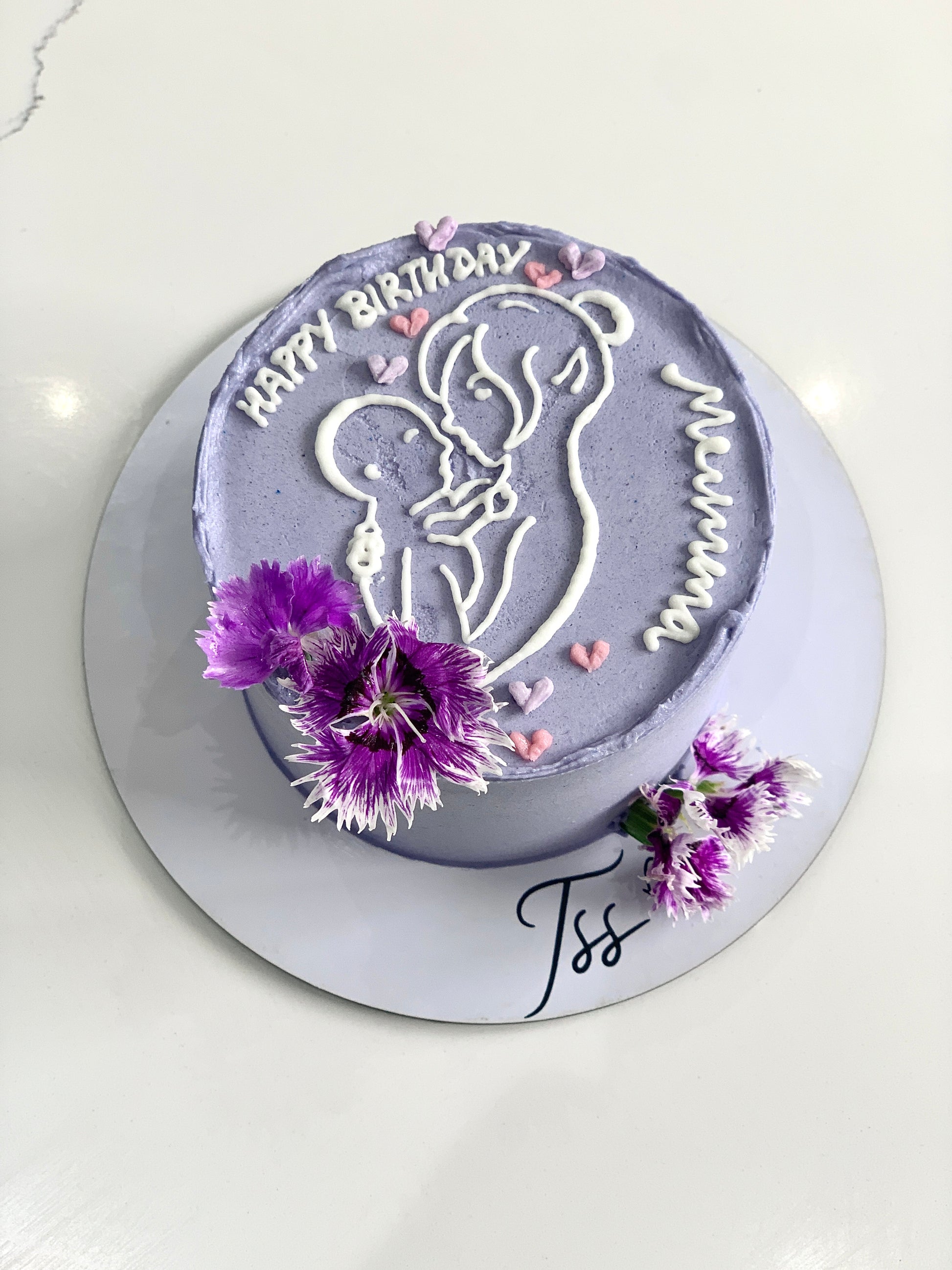 Decorative Mother's Day cake from The Sinful Spoon with floral frosting and elegant piping for a special celebration.