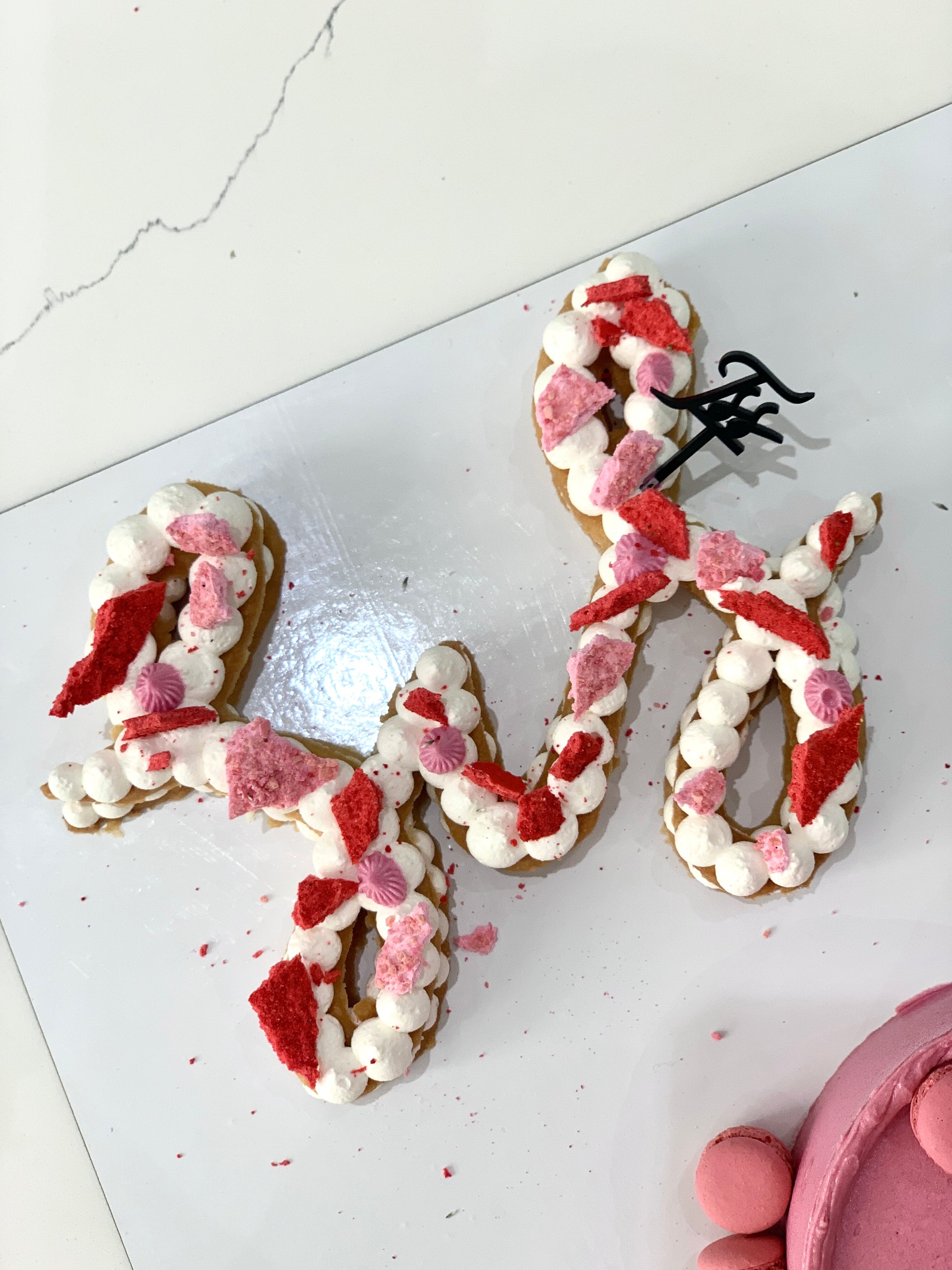 Decorative festive cakes from The Sinful Spoon featuring colorful icing and holiday-themed designs.