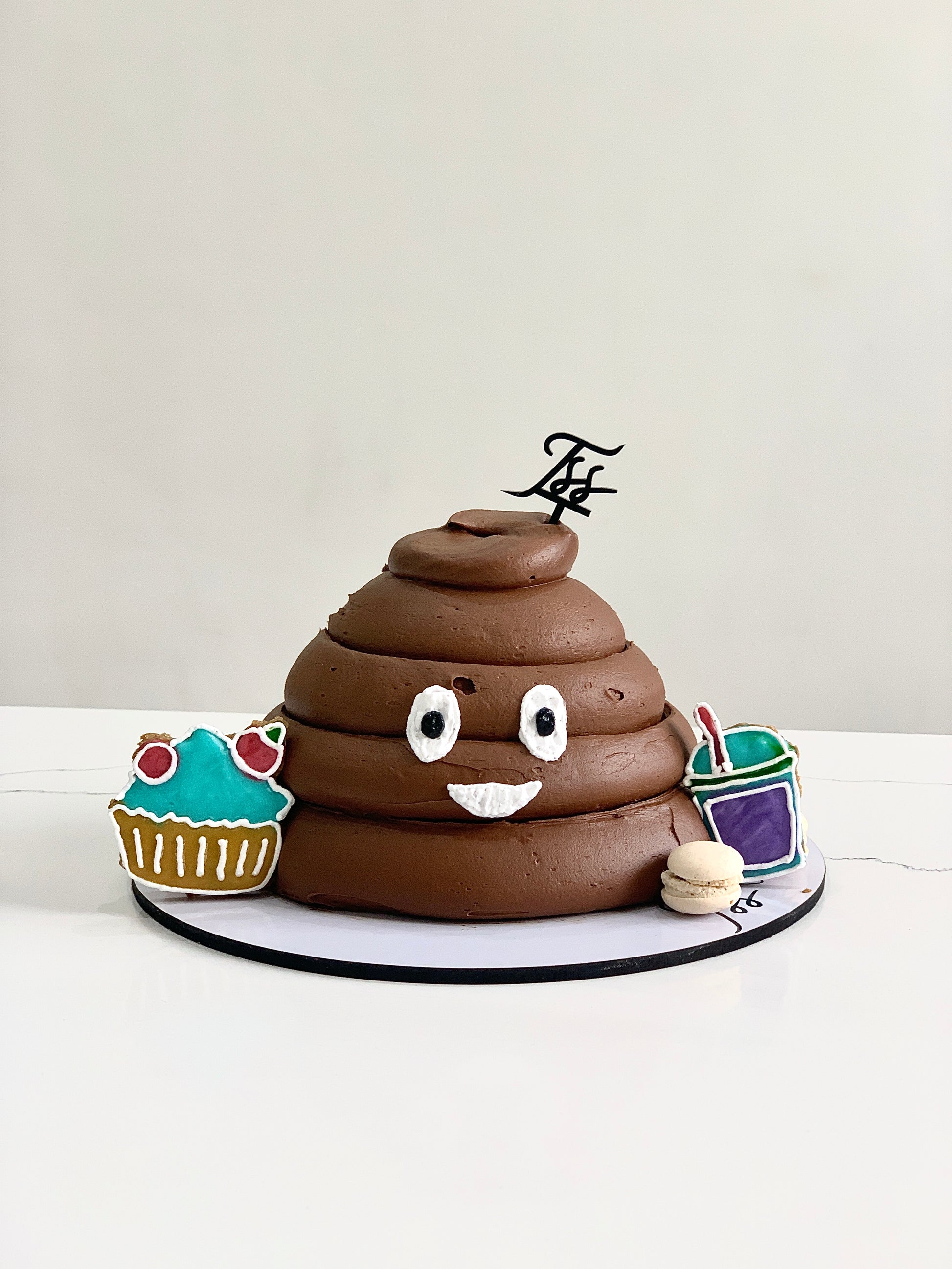 Decorative shape cakes by The Sinful Spoon featuring colorful, intricate designs on a white background.