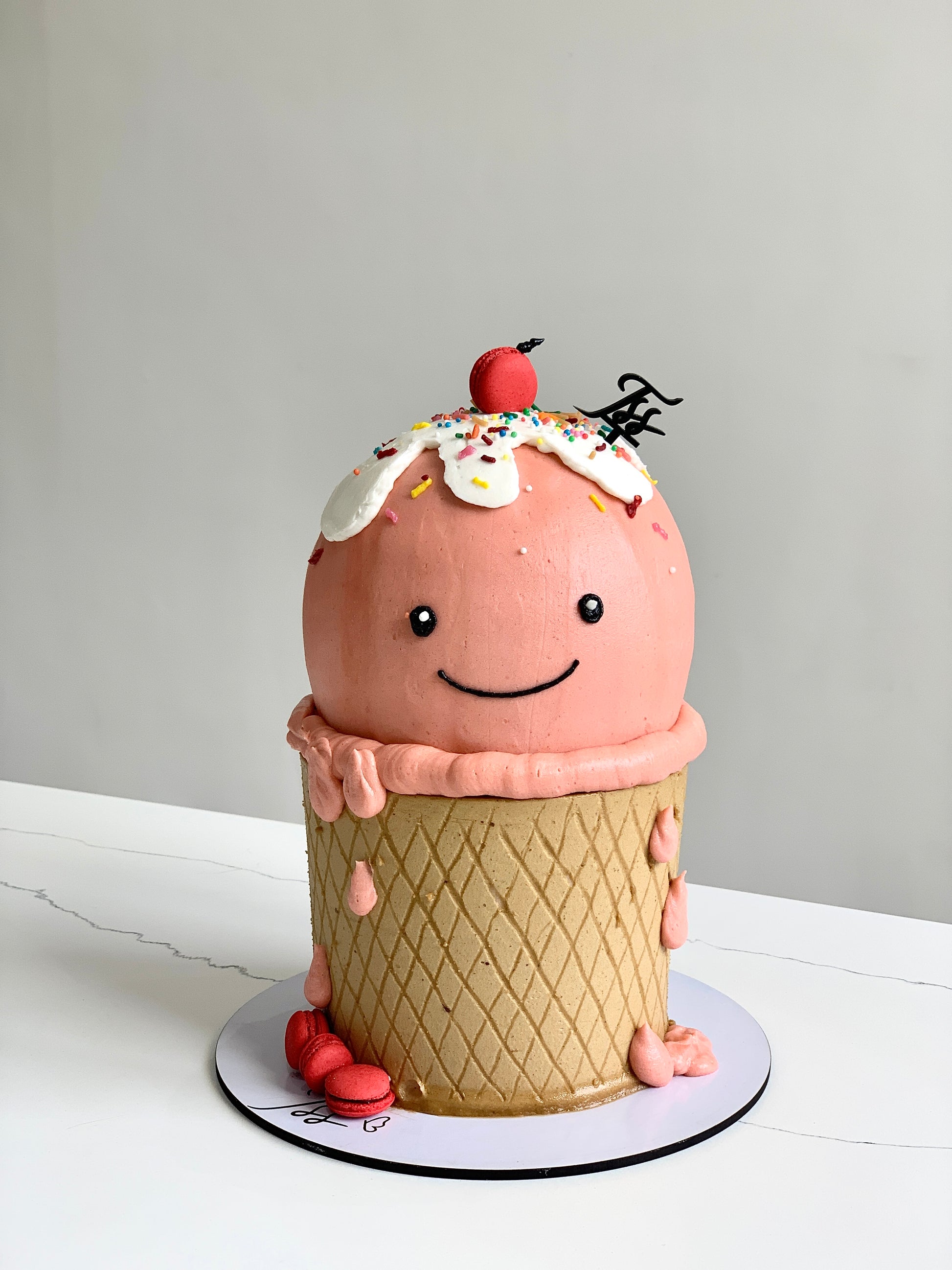 Decorative shape cakes from The Sinful Spoon featuring colorful, intricate designs on a white background.