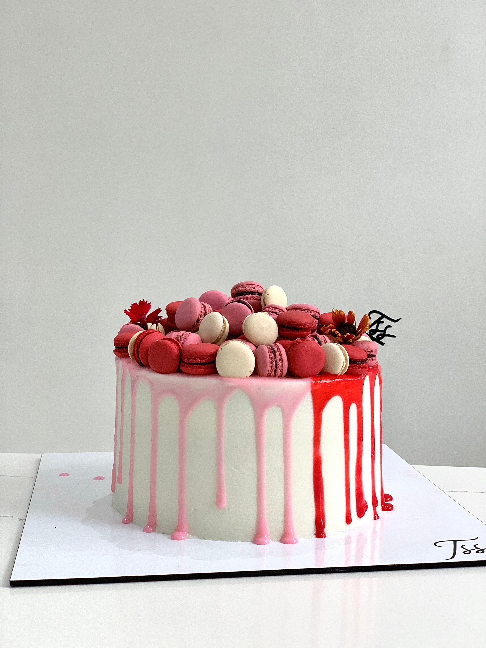 Slice of Classic Cakes by The Sinful Spoon showing layered chocolate and vanilla cake with frosting on a white plate.