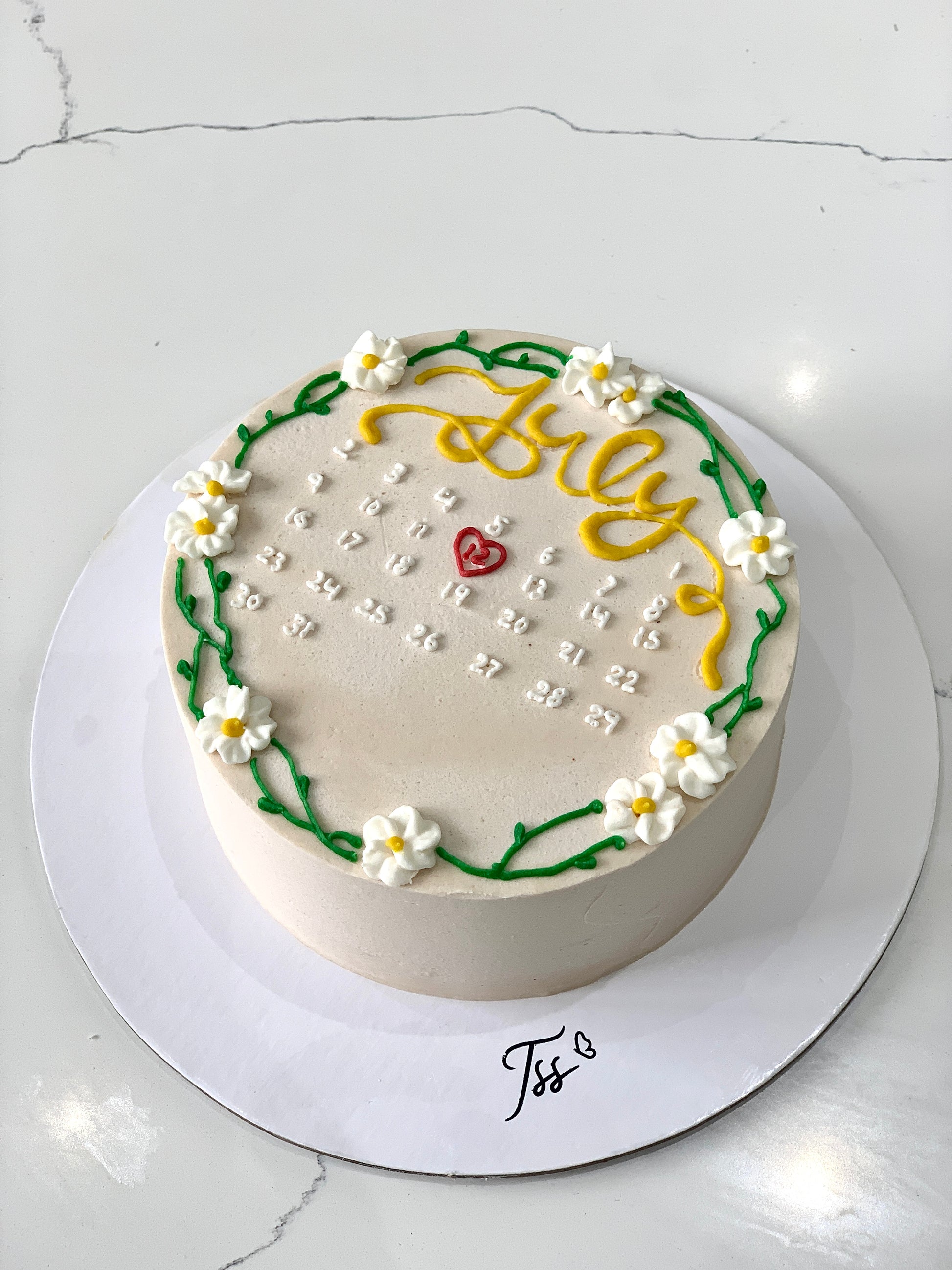 Decorative buttercream flower cakes by The Sinful Spoon featuring colorful, intricate floral designs on a cake.