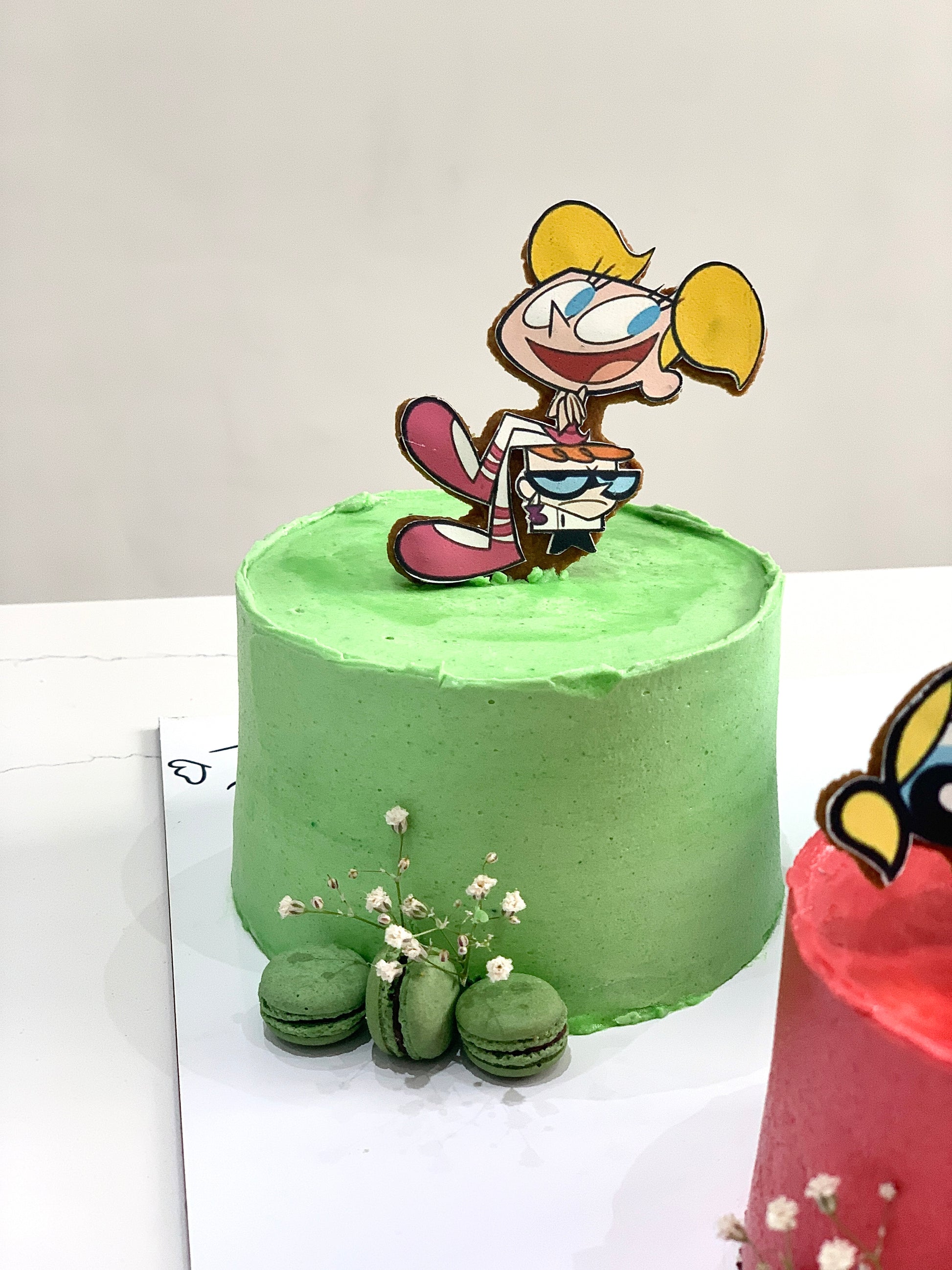 Decorative festive cakes from The Sinful Spoon, featuring colorful icing and holiday-themed designs on a white background.