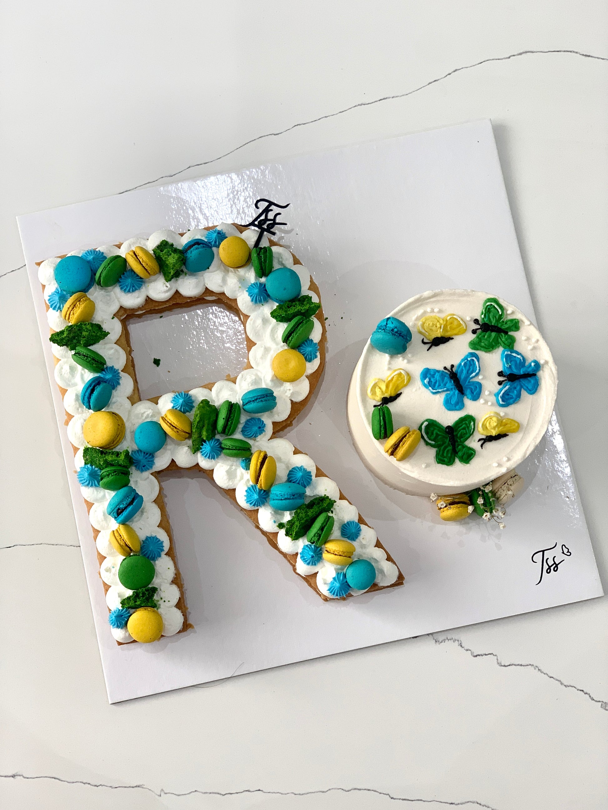 Assorted combo cakes from The Sinful Spoon displayed on a plate with colorful frosting and toppings, ready to serve.