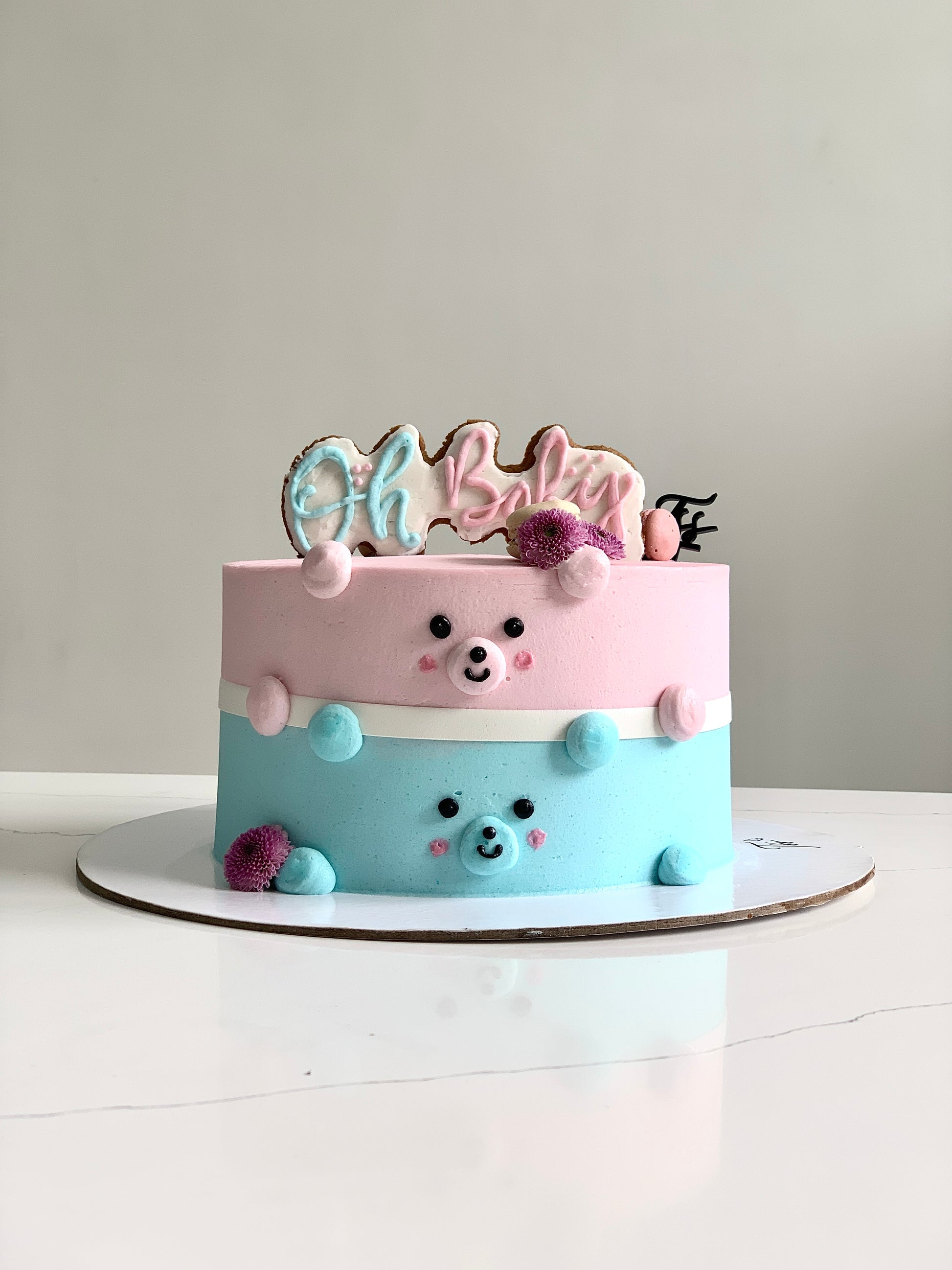 Decorative baby shower cake from The Sinful Spoon with pastel colors and adorable baby-themed decorations.