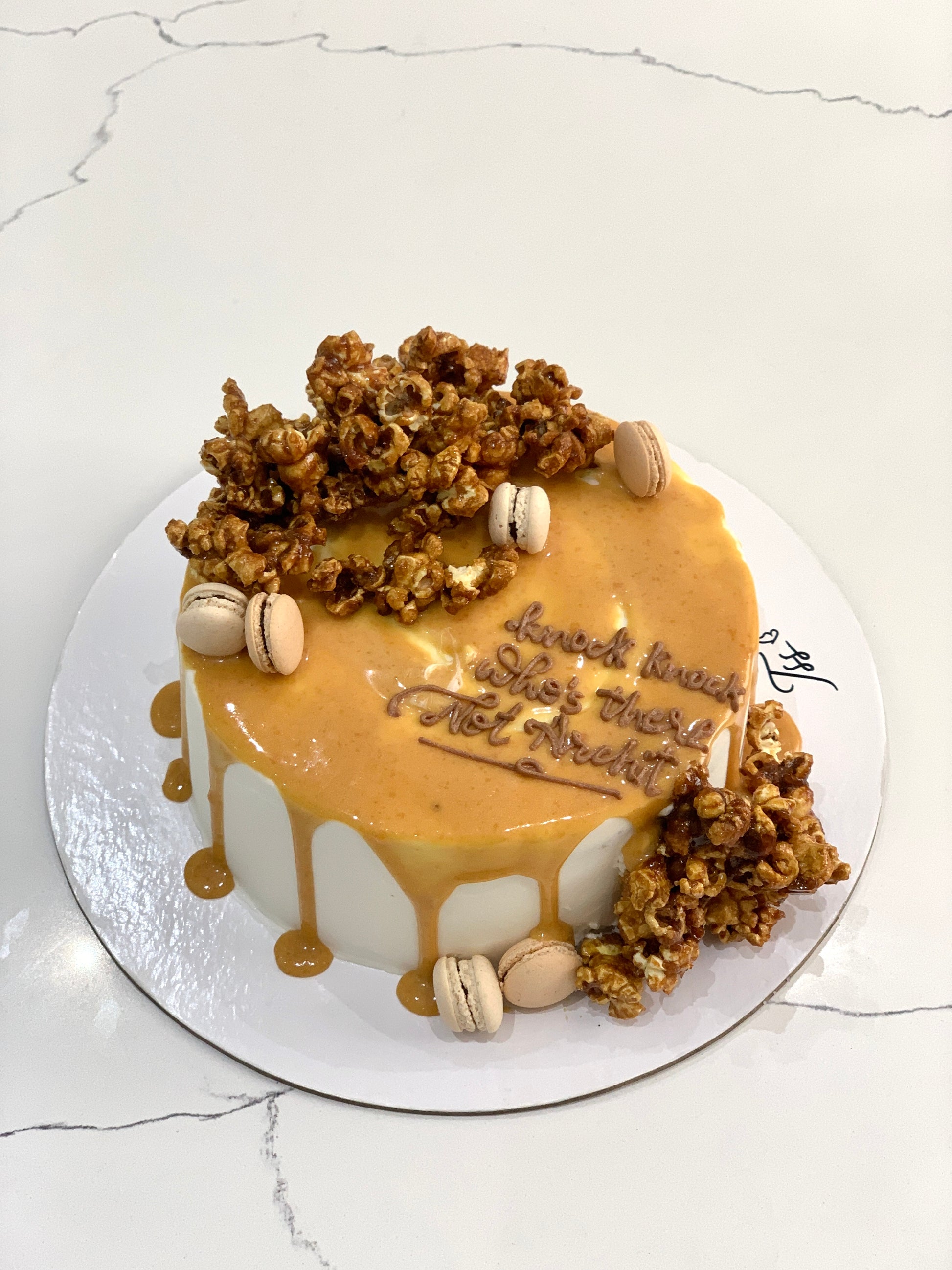 Slice of Classic Cakes from The Sinful Spoon showing layered cake with frosting and decorative toppings.