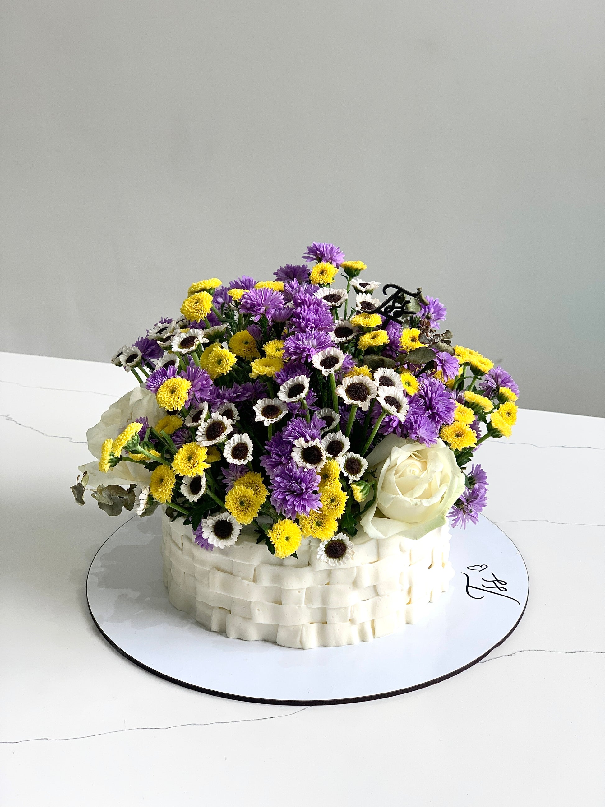 Fresh floral cakes from The Sinful Spoon, decorated with colorful edible flowers and intricate icing details.