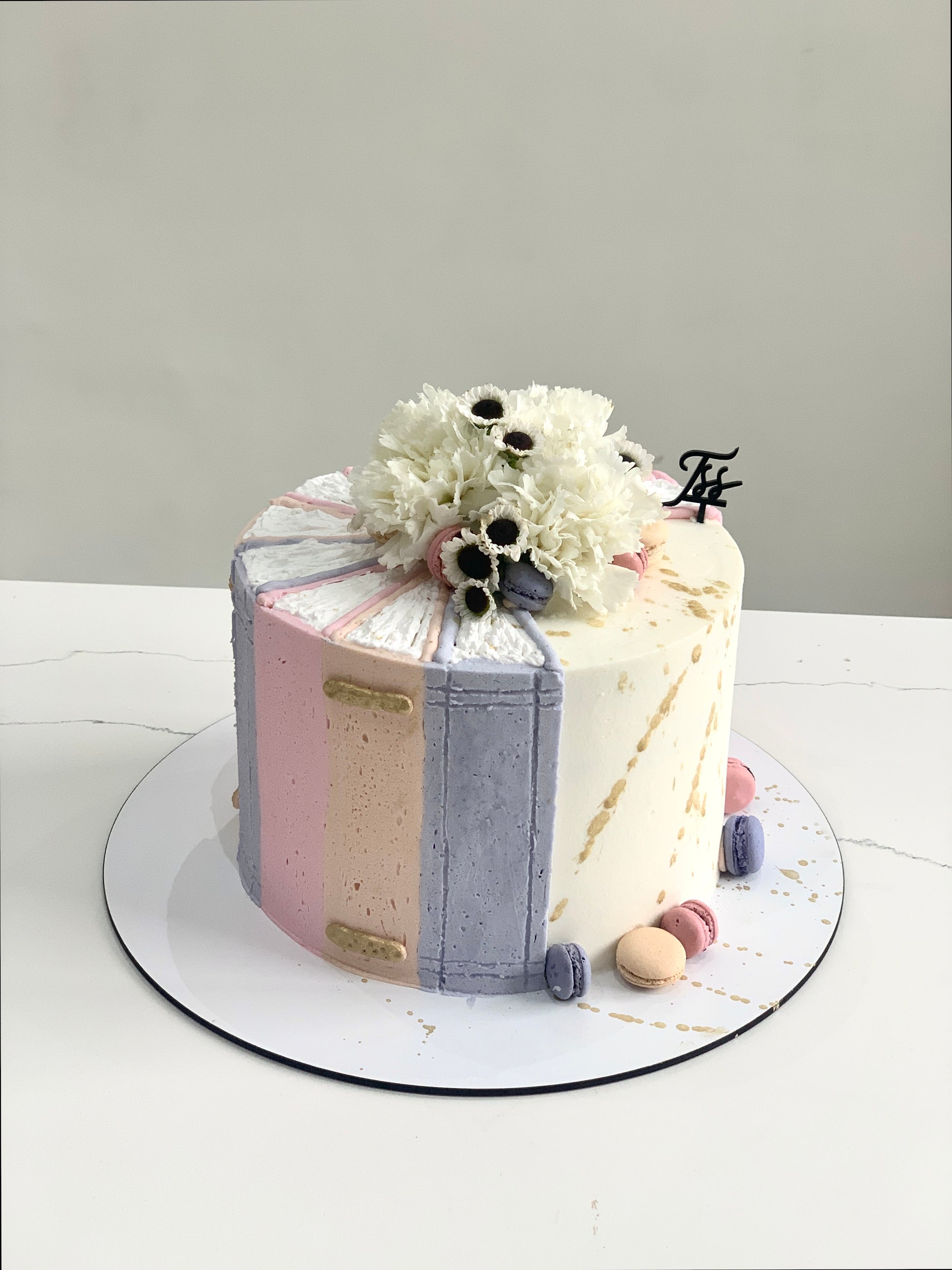 Fresh floral cakes from The Sinful Spoon featuring beautifully decorated cakes with colorful edible flowers and intricate frosting details.