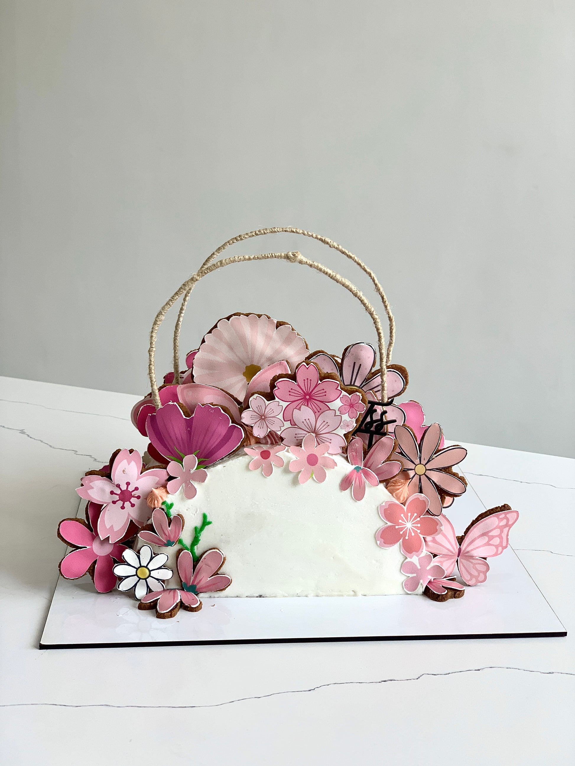 Edible paper cake featuring a baby girl design by The Sinful Spoon, decorated with pastel colors and intricate details for special occasions.