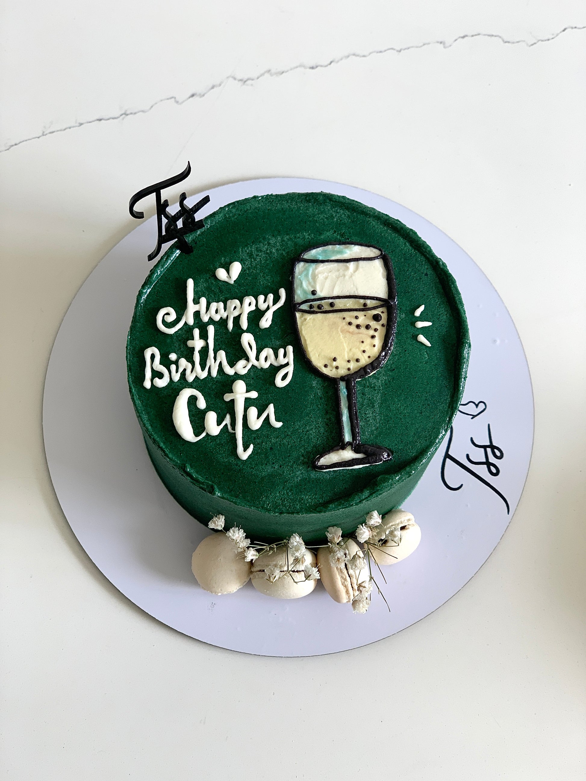 Decorative buttercream illustration cake from The Sinful Spoon with colorful floral and whimsical design on a white cake.