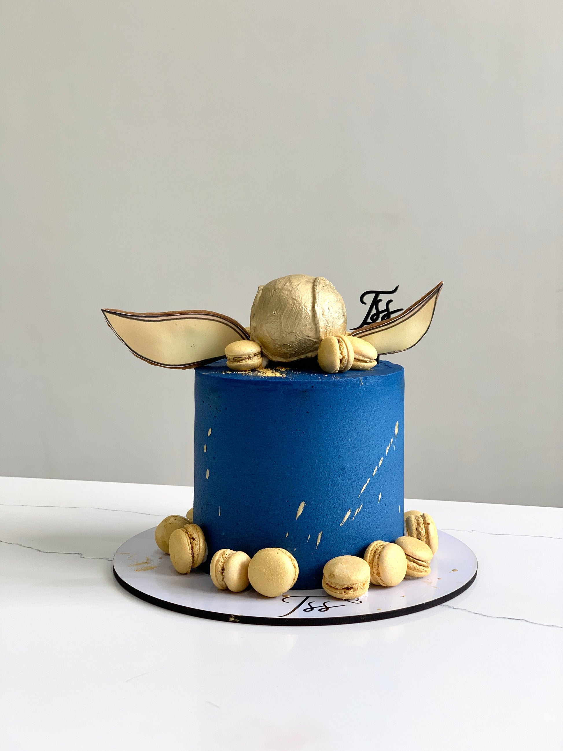 Edible paper cake for baby boy by The Sinful Spoon, decorated with blue and white baby-themed designs on a cake.