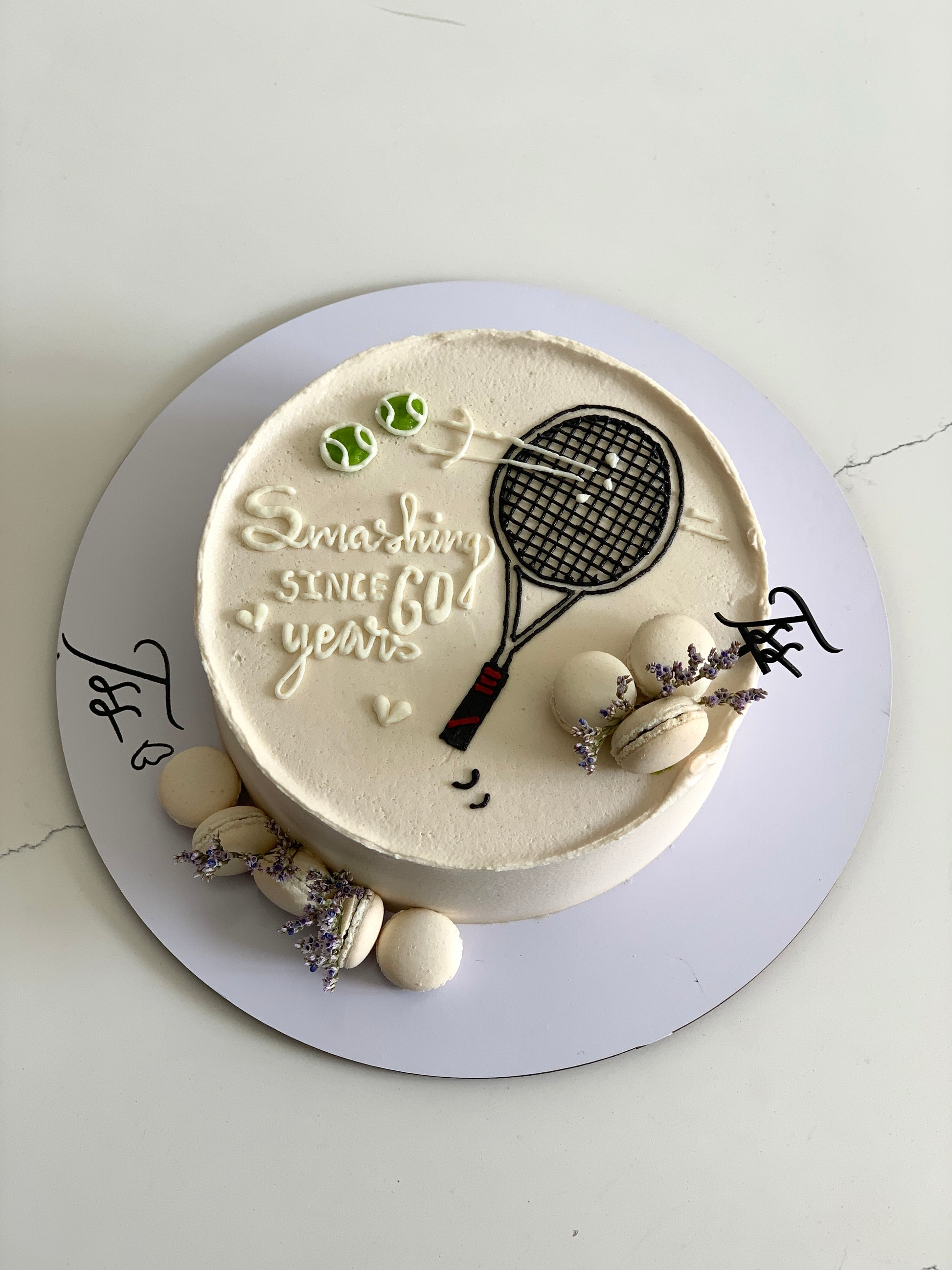Colorful buttercream illustration cake from The Sinful Spoon with vibrant floral and character designs on smooth fondant.