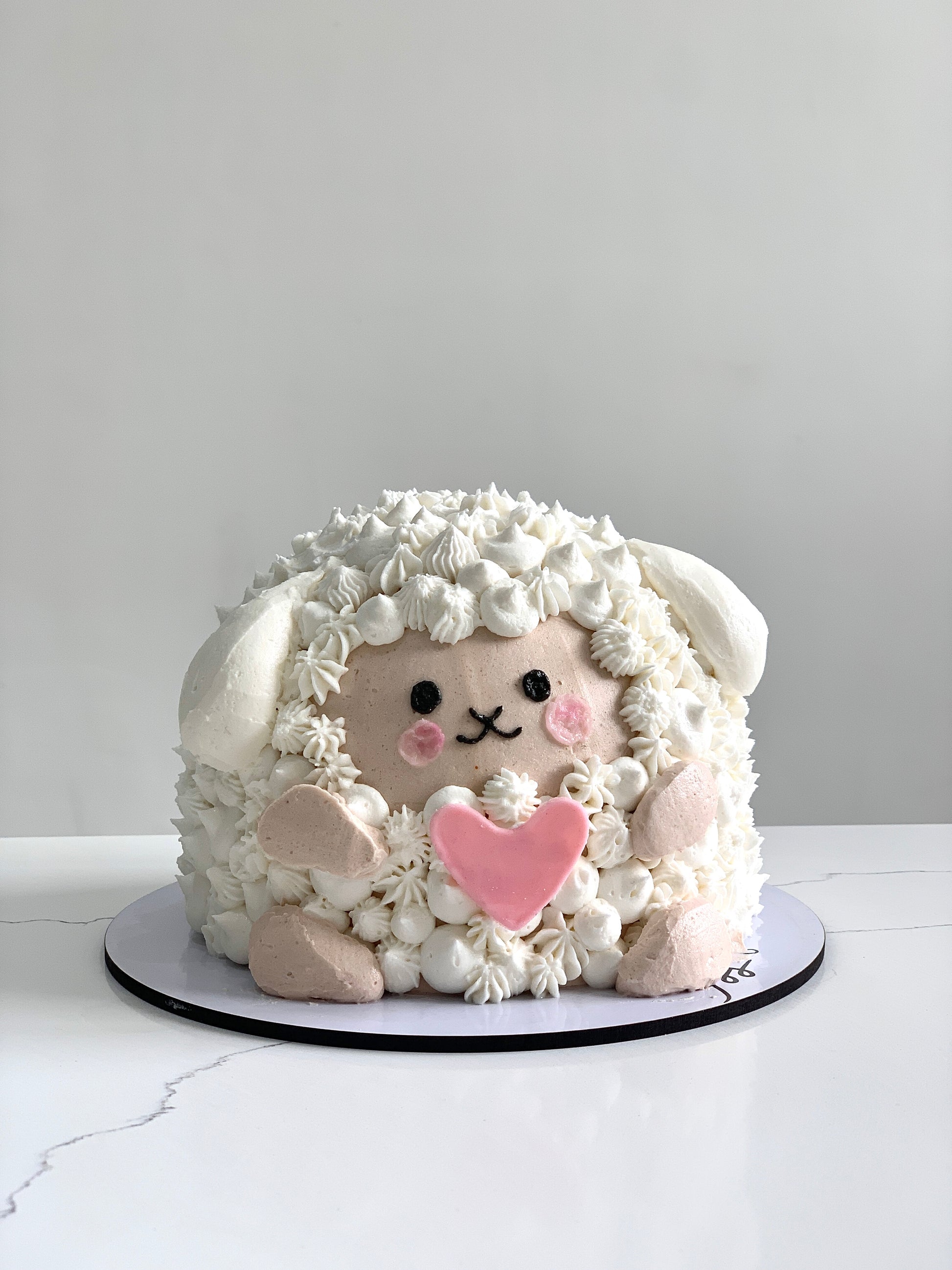 Decorative shape cakes from The Sinful Spoon, featuring colorful icing and creative designs on a white background.
