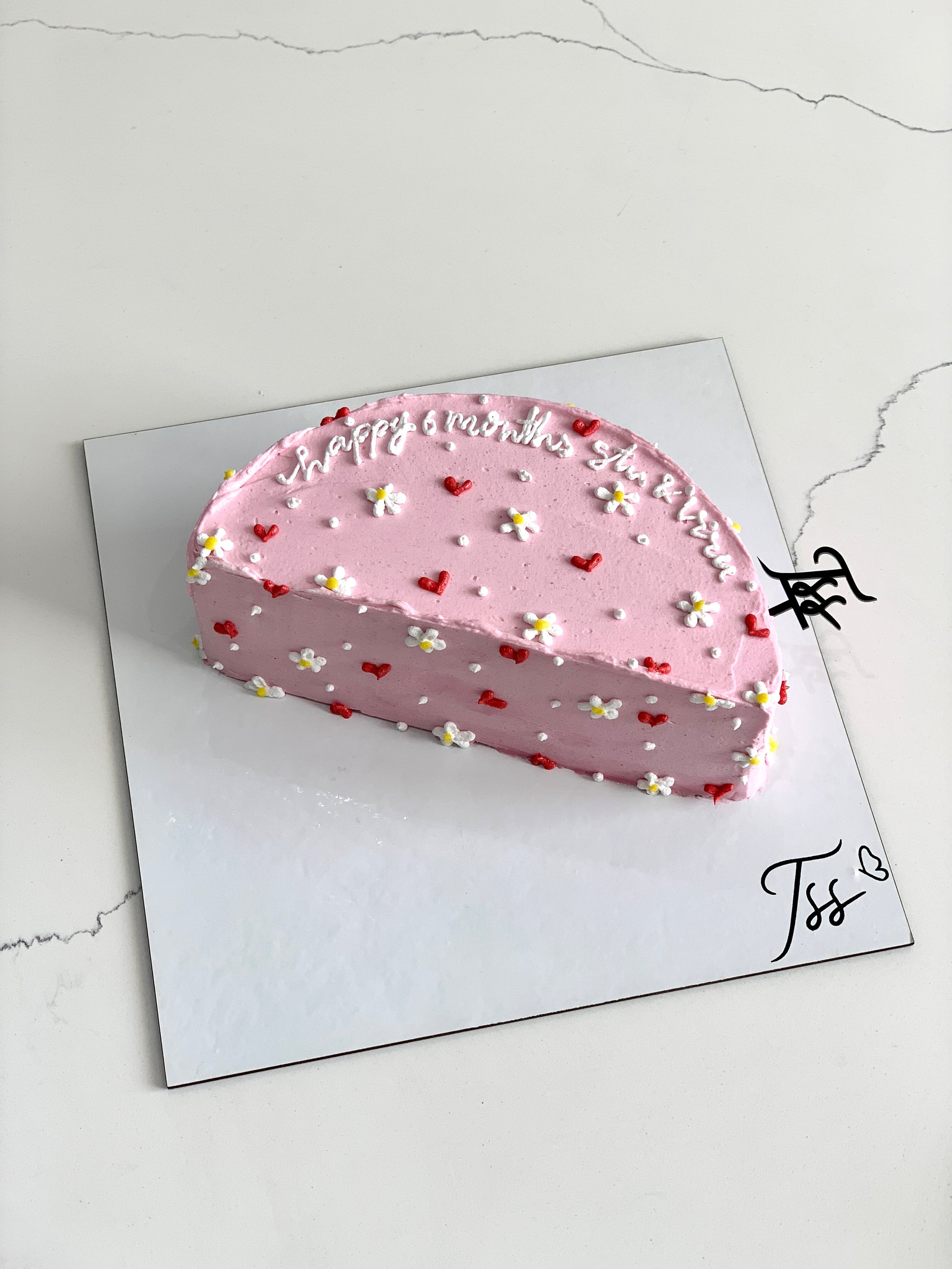 Half birthday cake from The Sinful Spoon with colorful icing and festive decorations, perfect for celebrating special milestones.