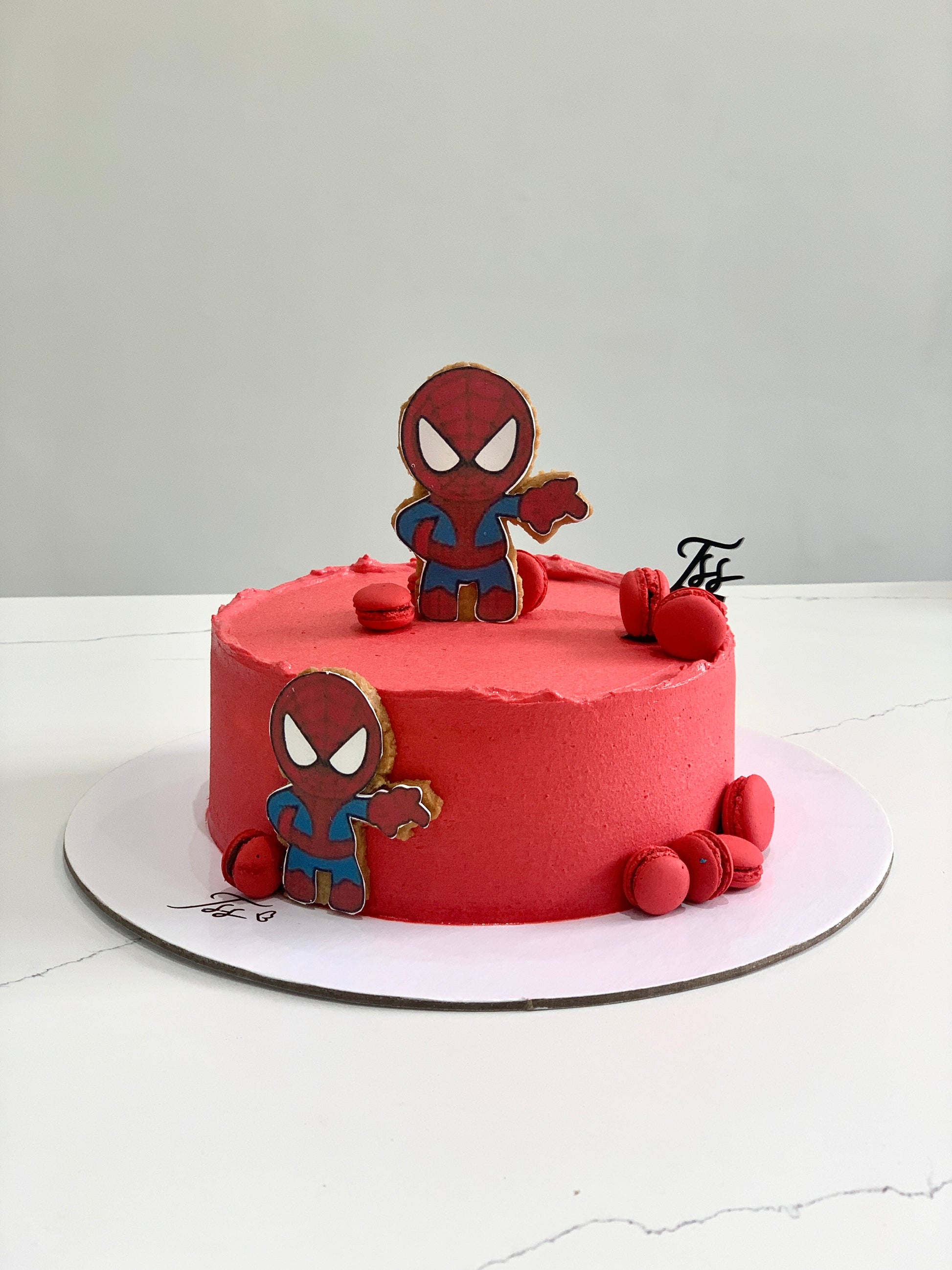 Edible paper cake decorated for a baby boy occasion by The Sinful Spoon, featuring colorful baby-themed designs on a cake.