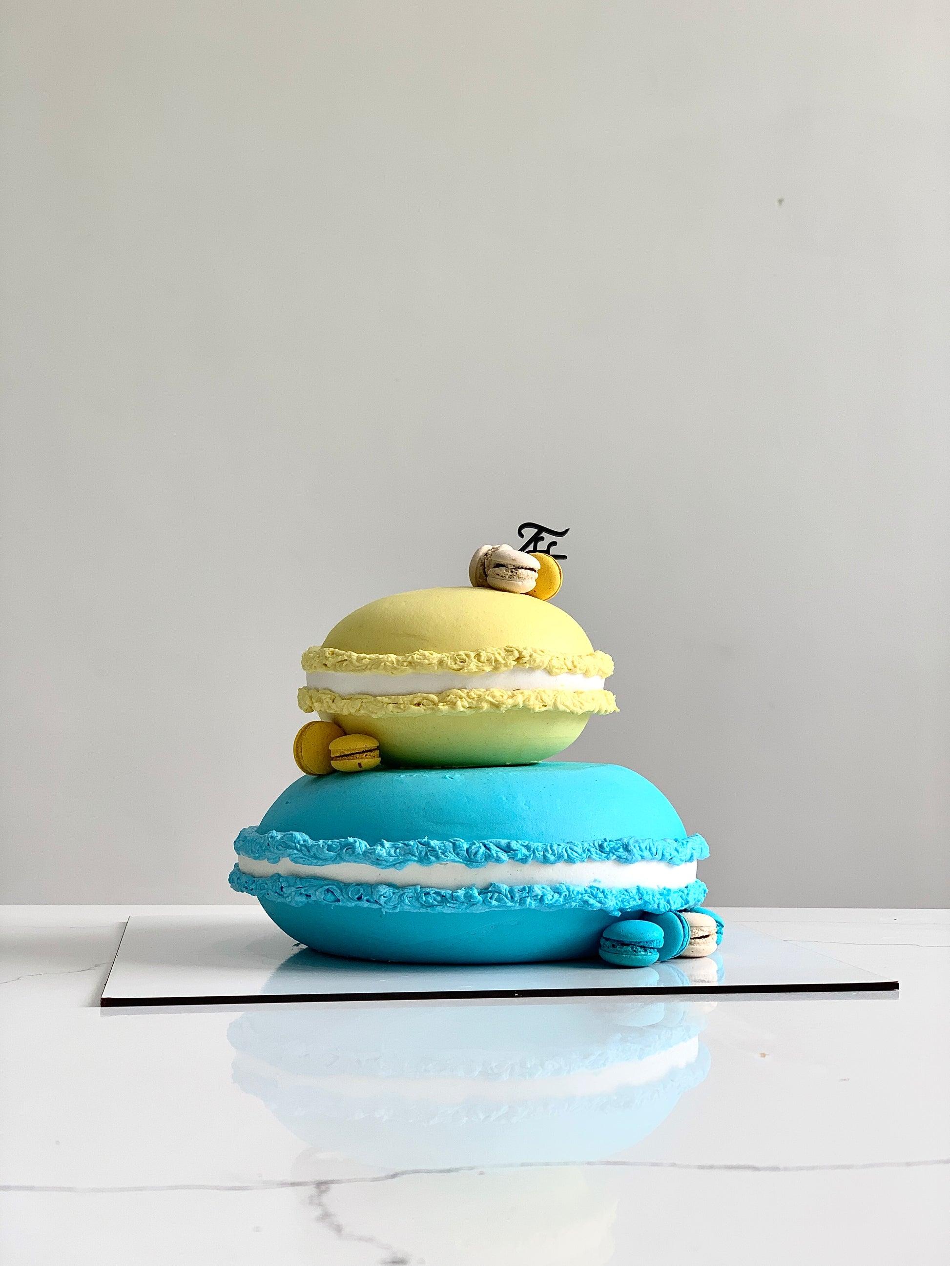 Colorful shape cakes from The Sinful Spoon arranged on a plate, showcasing vibrant, decorative baked treats.