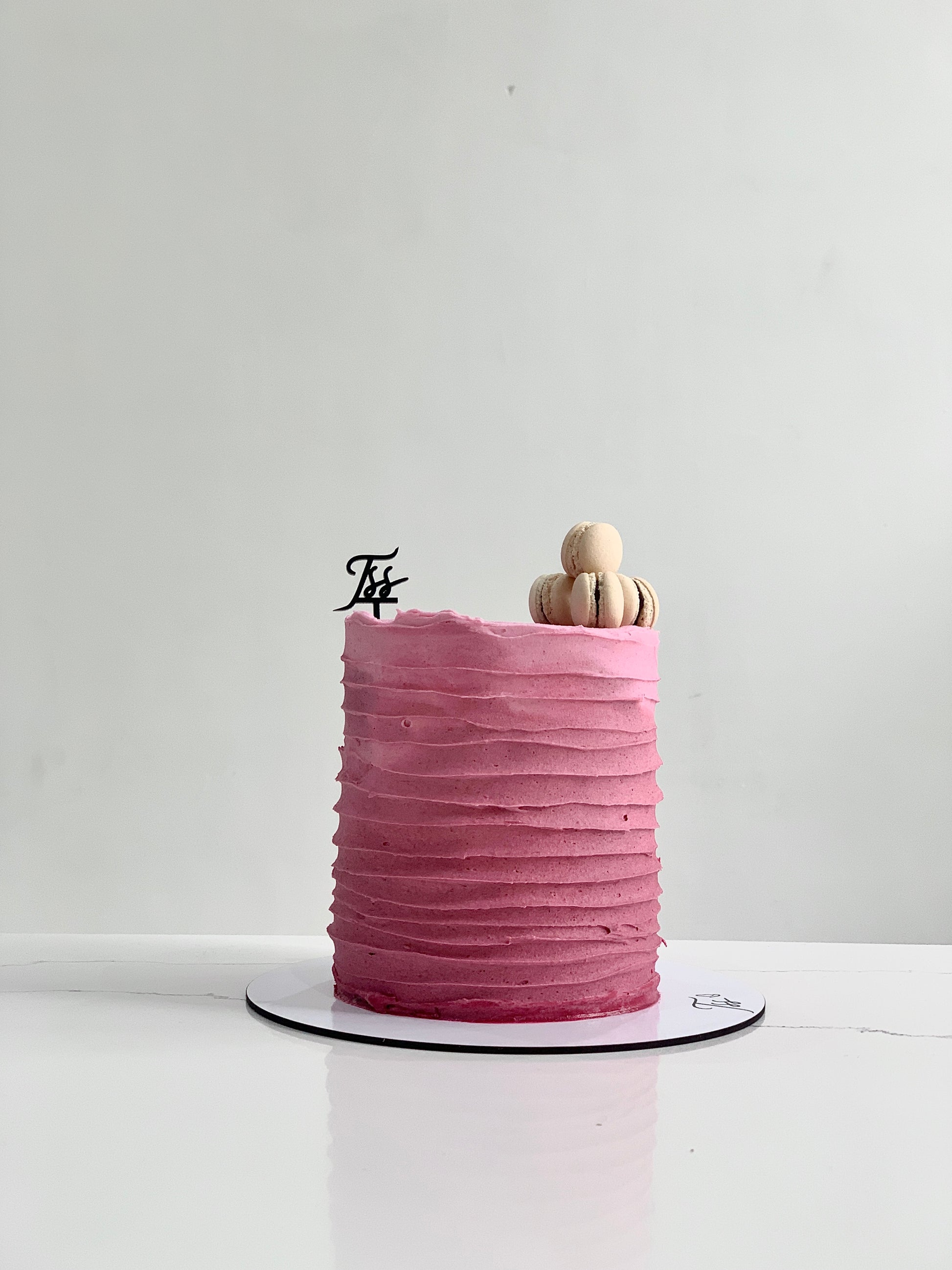 Chocolate layered cake from Classic Cakes by The Sinful Spoon with creamy frosting and decorative chocolate drizzle.