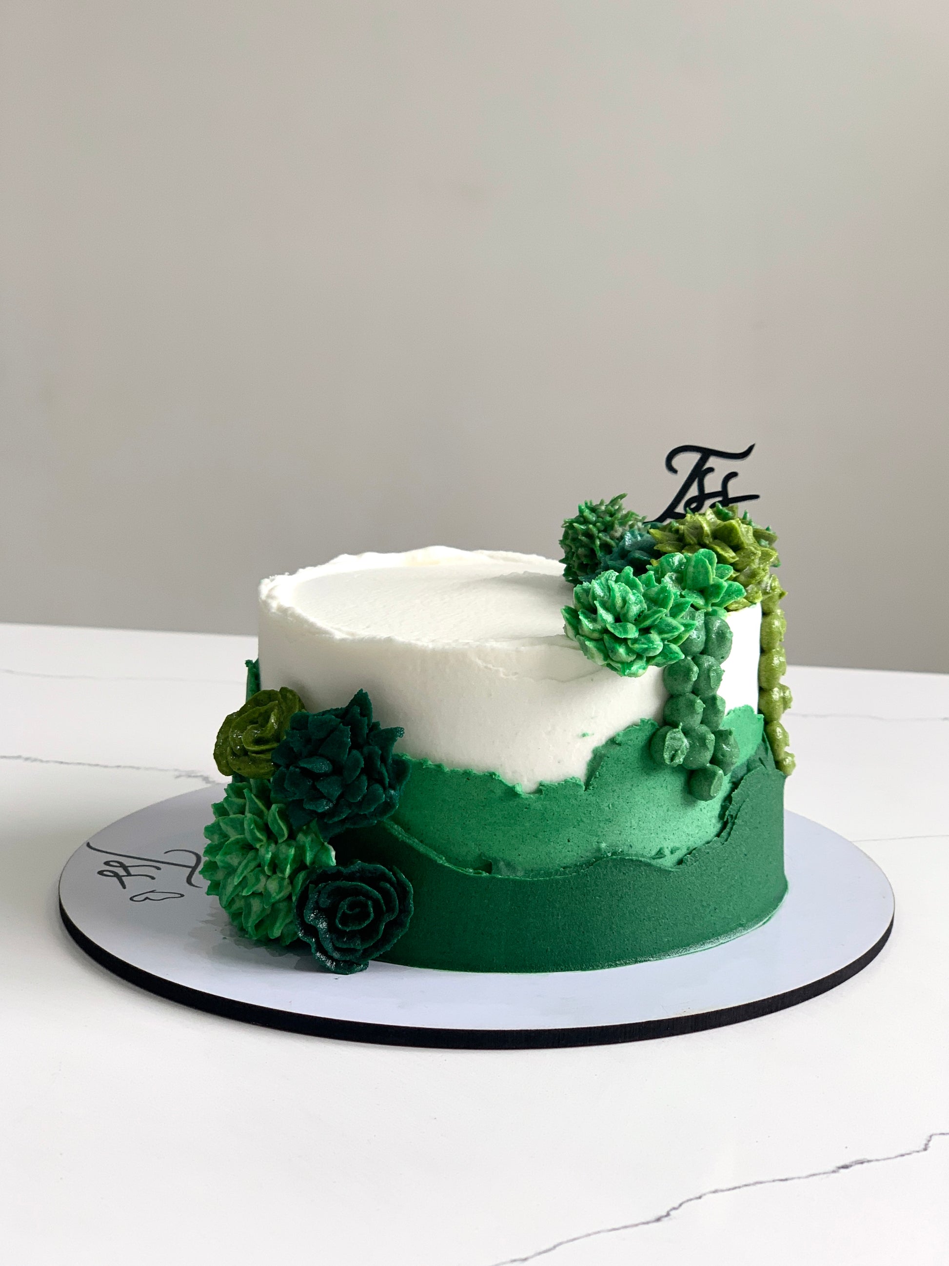 Decorative buttercream flower cakes by The Sinful Spoon featuring colorful floral designs and intricate piping details.