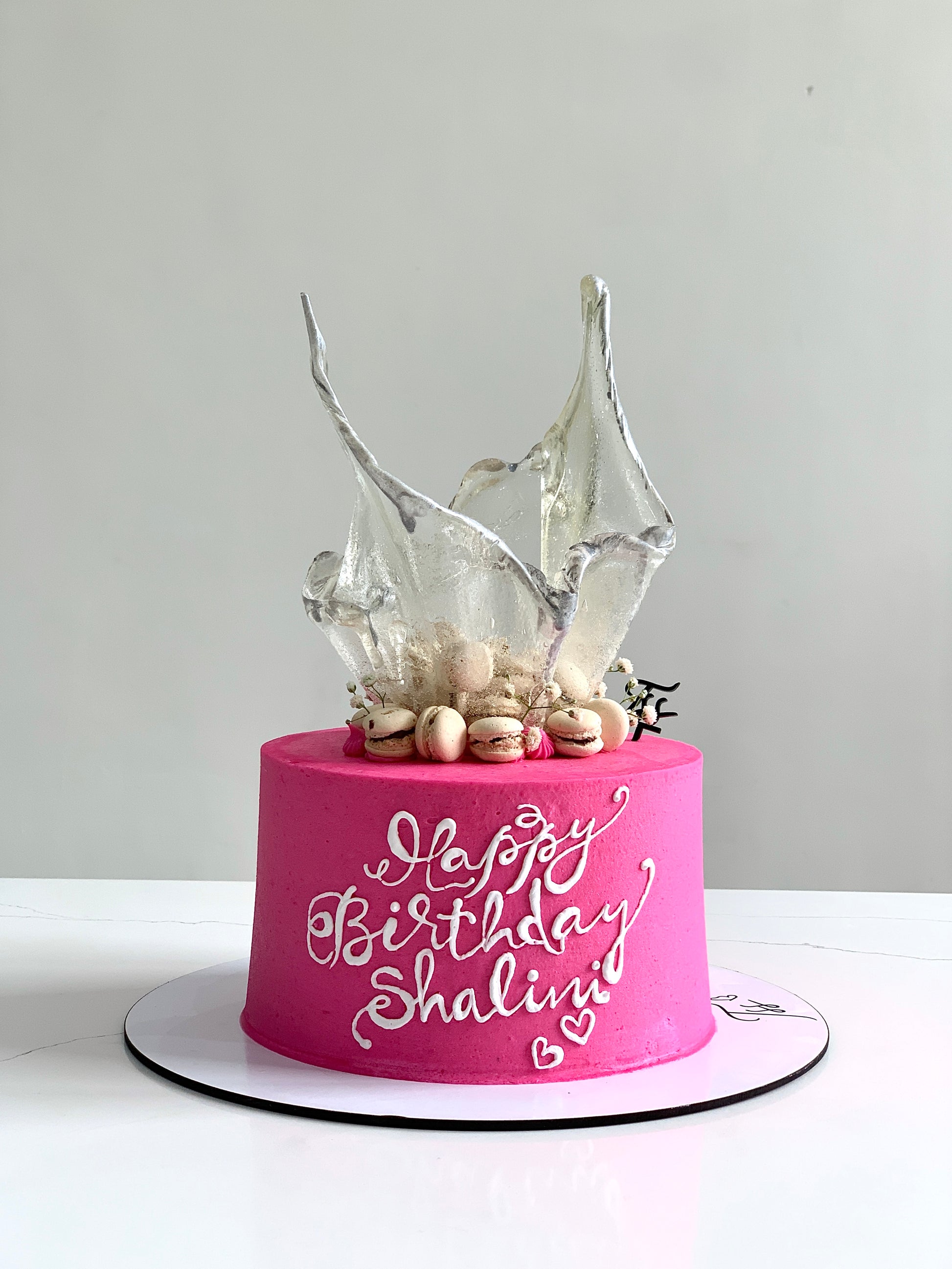 Colorful isomalt cakes by The Sinful Spoon, showcasing vibrant, glossy sugar sculptures perfect for cake decorating.