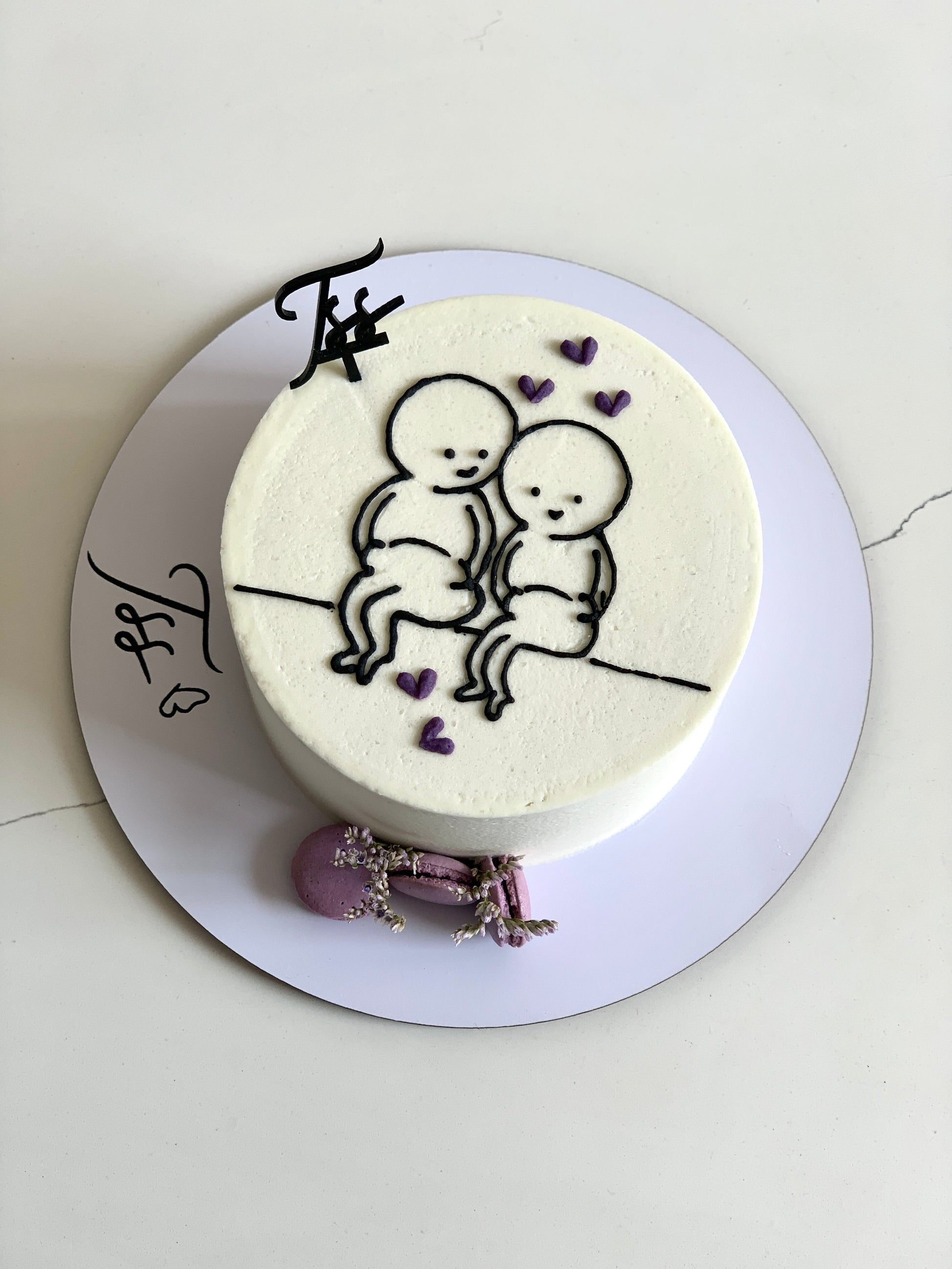 Colorful buttercream illustration cakes from The Sinful Spoon with detailed, artistic frosting designs and vibrant decorative elements.