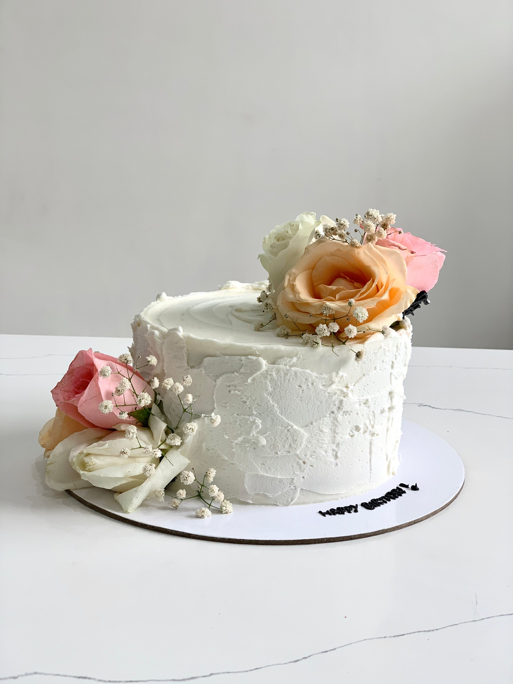 Fresh floral cakes by The Sinful Spoon featuring colorful icing and edible flowers on elegant cake bases.