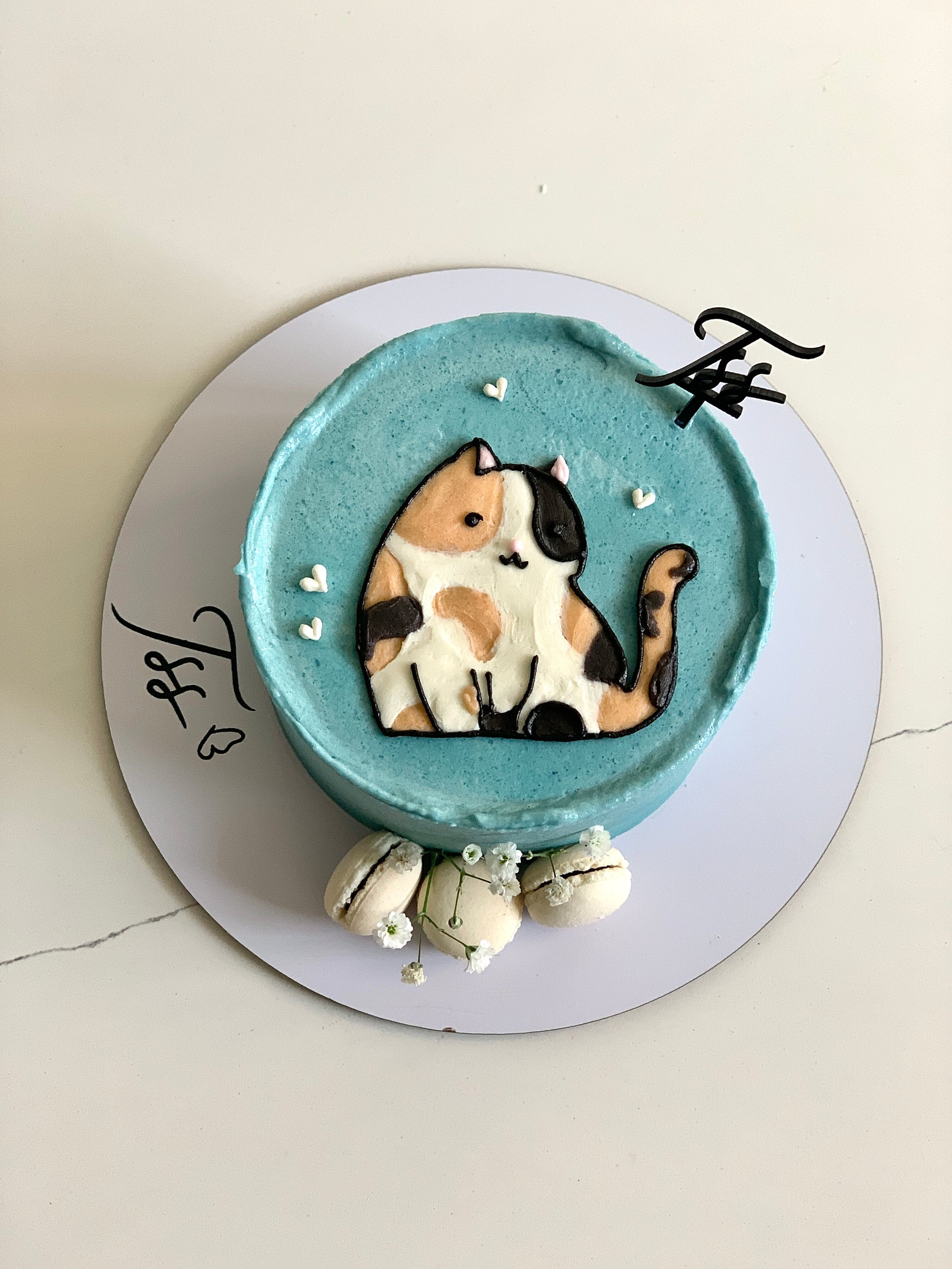 Decorative buttercream illustration cake by The Sinful Spoon featuring colorful floral and artistic piping details.