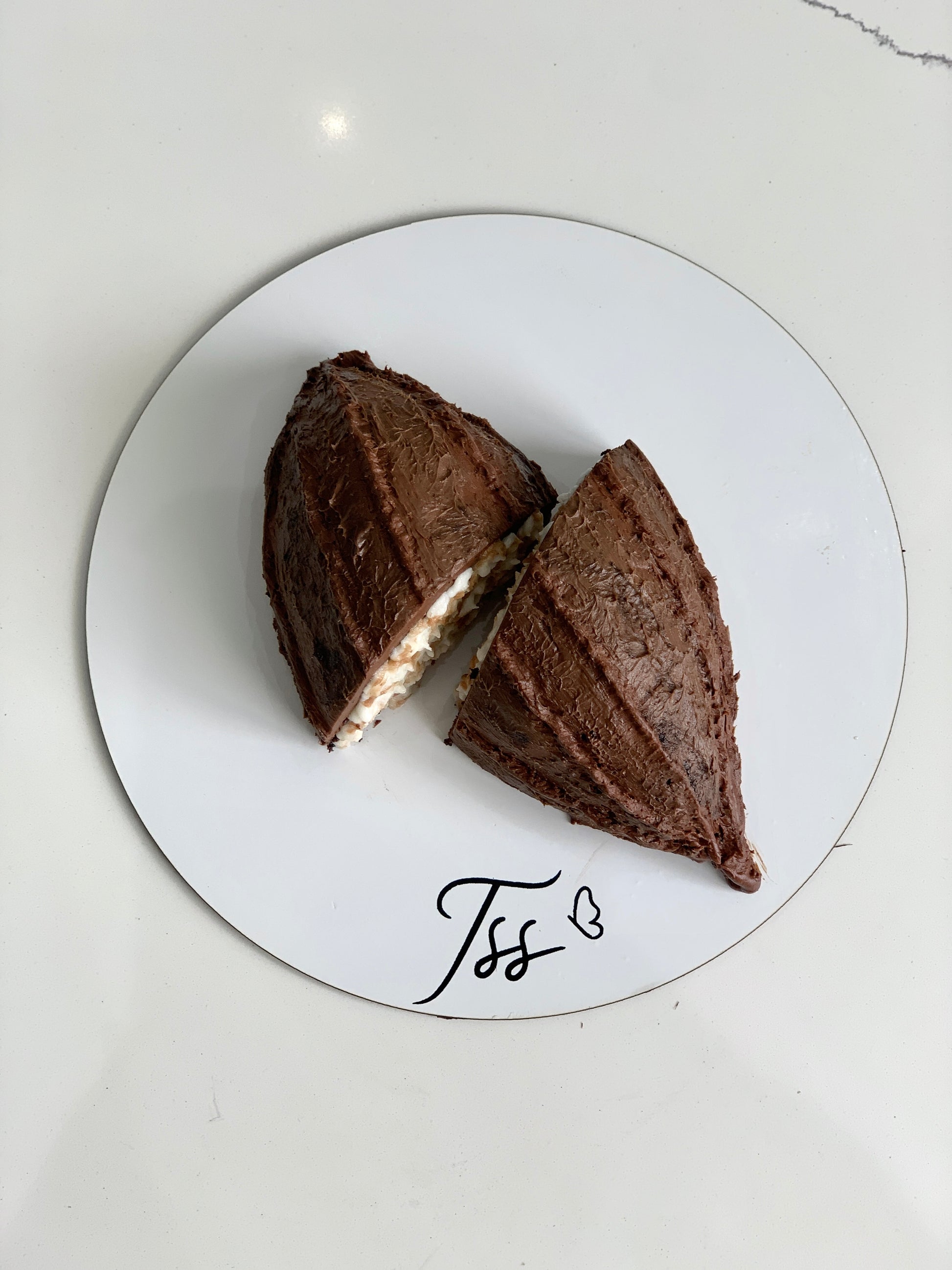 Decorative shape cakes from The Sinful Spoon featuring colorful, detailed designs on smooth cake surfaces.