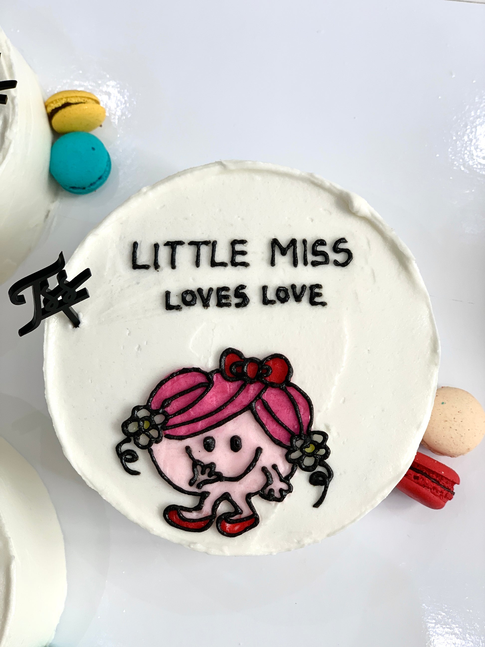 Valentine's Day cake from The Sinful Spoon with red and pink frosting, decorated with heart-shaped accents.