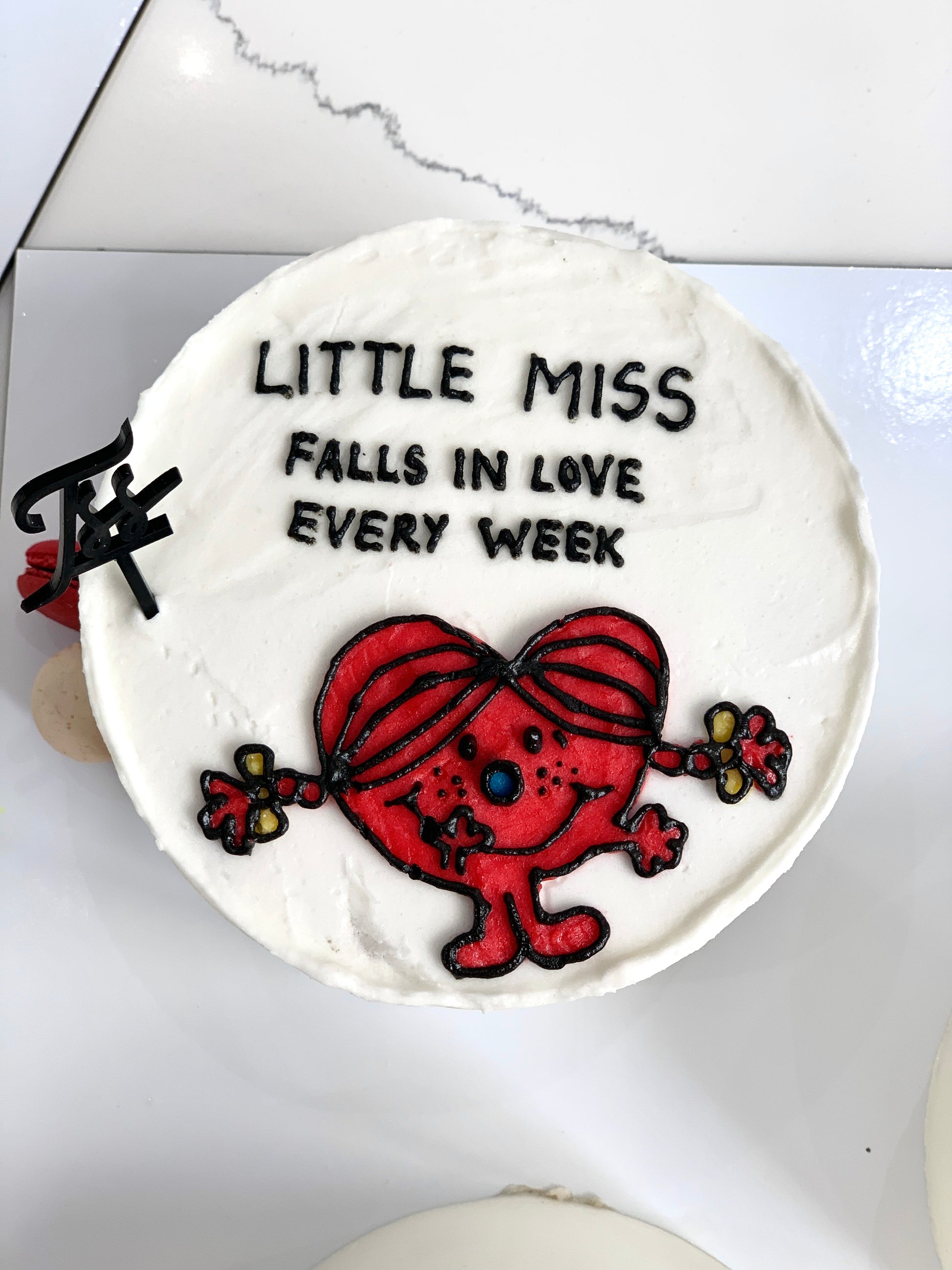 Valentine's Day cake from The Sinful Spoon with red and pink frosting and decorative heart accents on a festive plate.