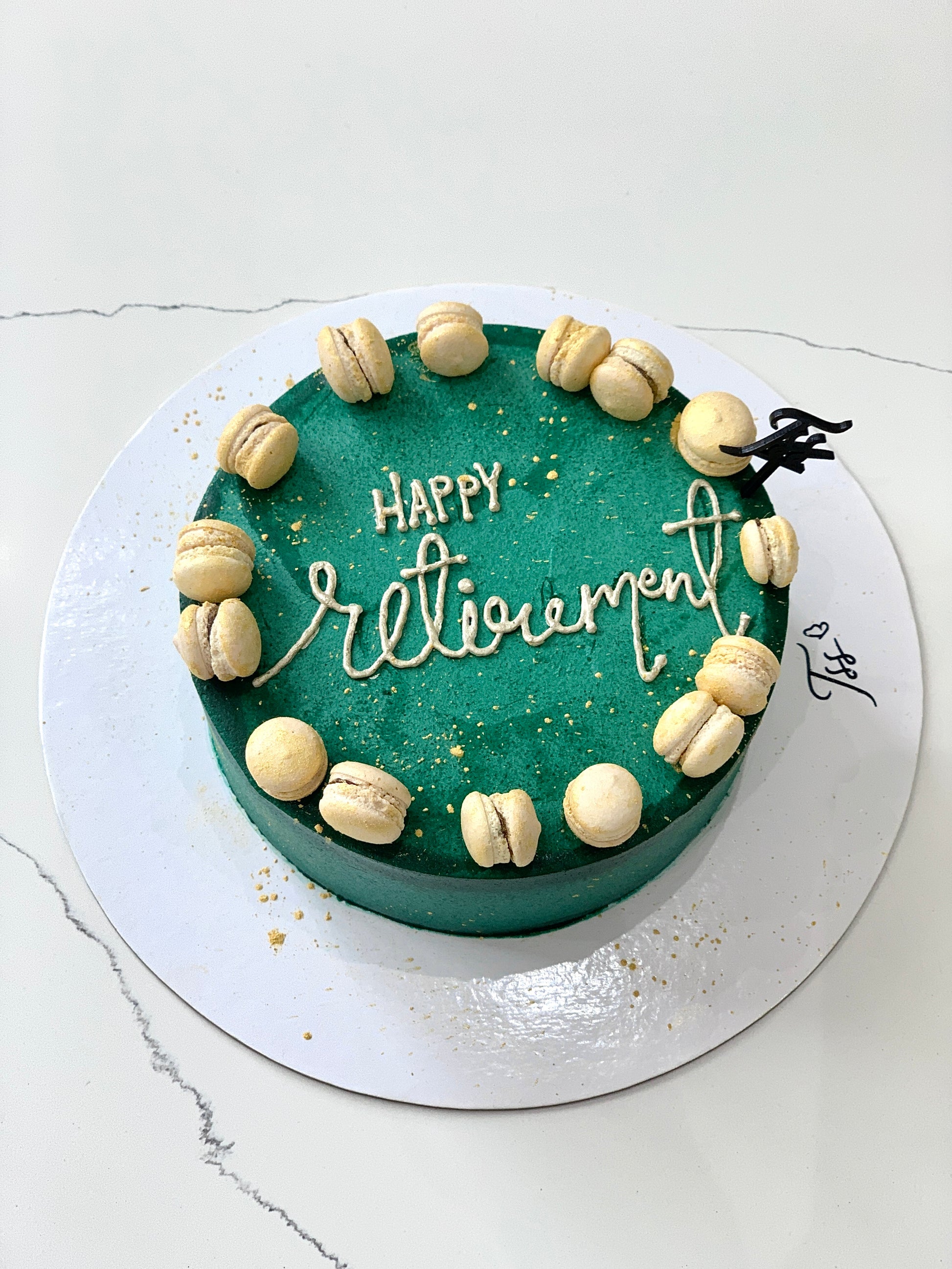 Slice of classic cake from The Sinful Spoon with creamy frosting and colorful sprinkles on a white plate.