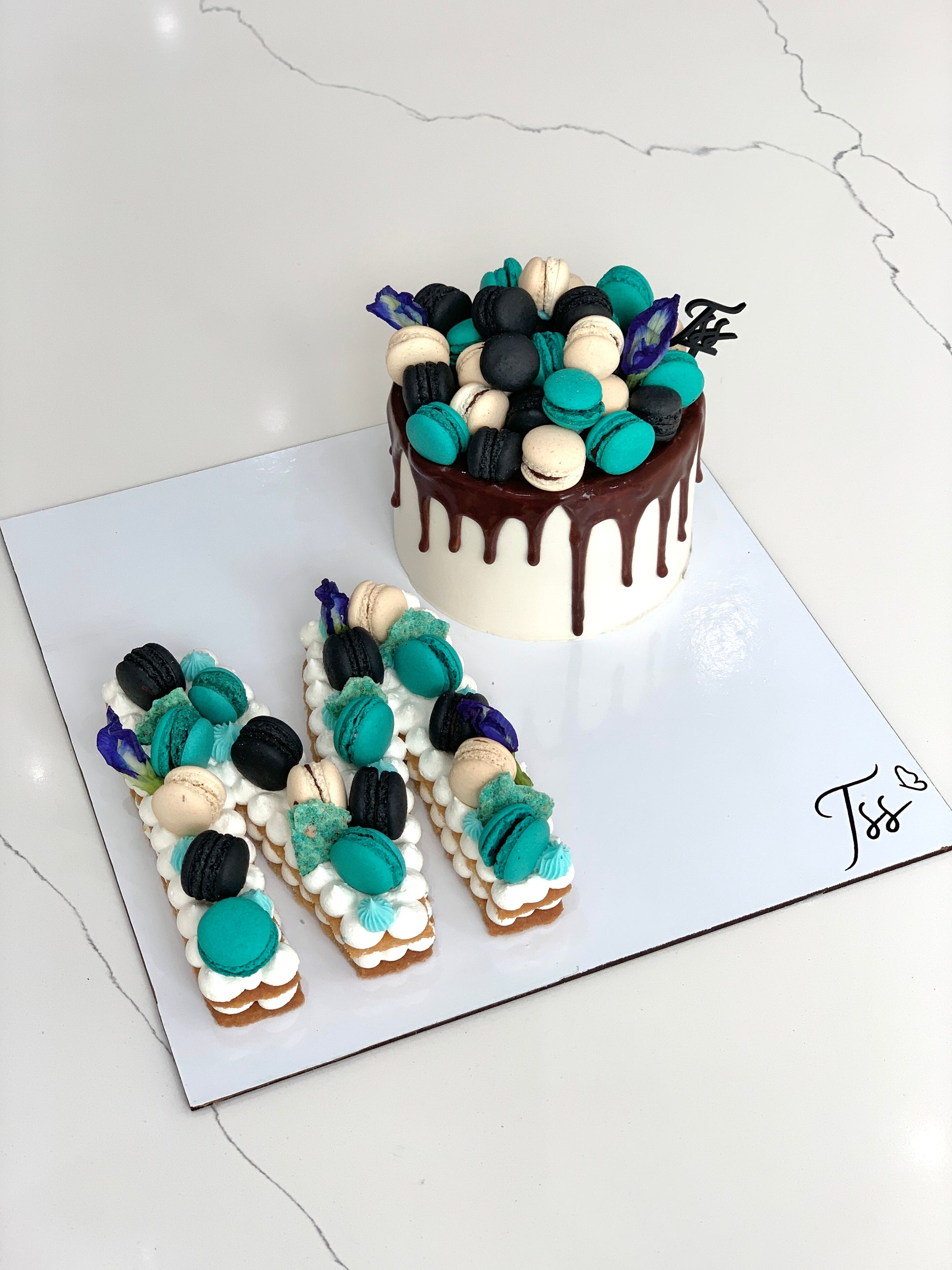 Assorted combo cakes from The Sinful Spoon featuring layered chocolate and vanilla desserts on a decorative plate