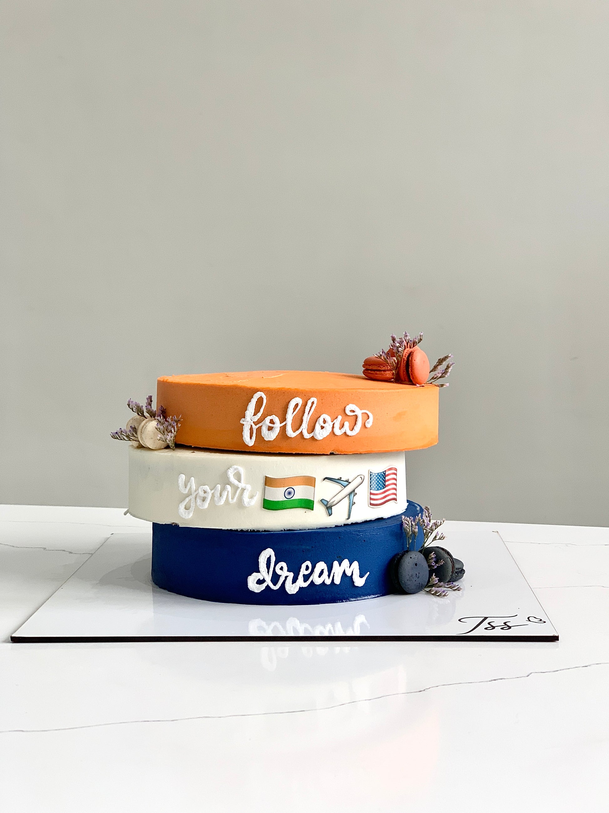 Asymmetrical cakes from The Sinful Spoon with layered frosting and creative design on a white plate.