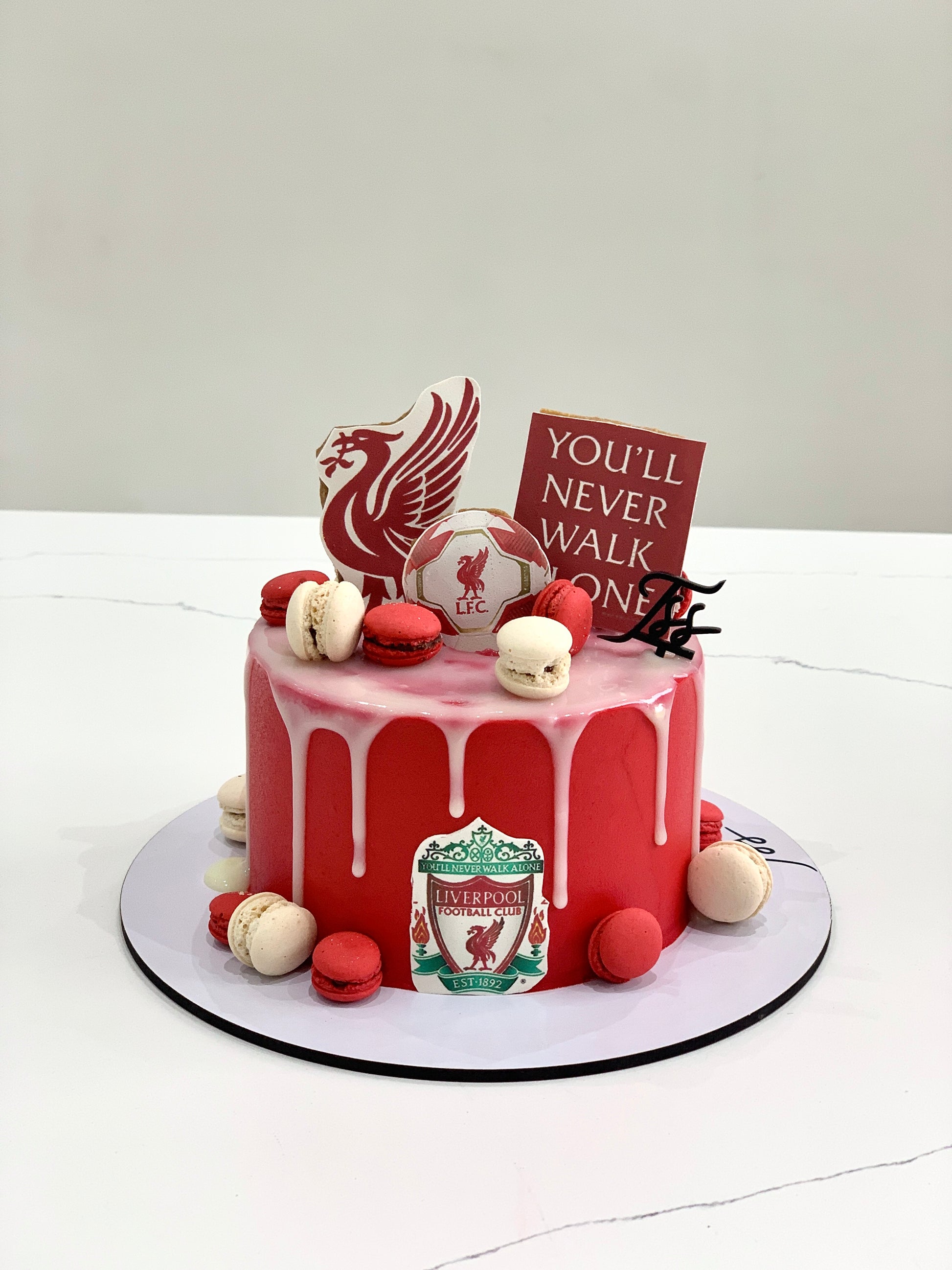 Edible paper cake featuring a baby boy design by The Sinful Spoon, decorated with colorful icing and edible decorations.