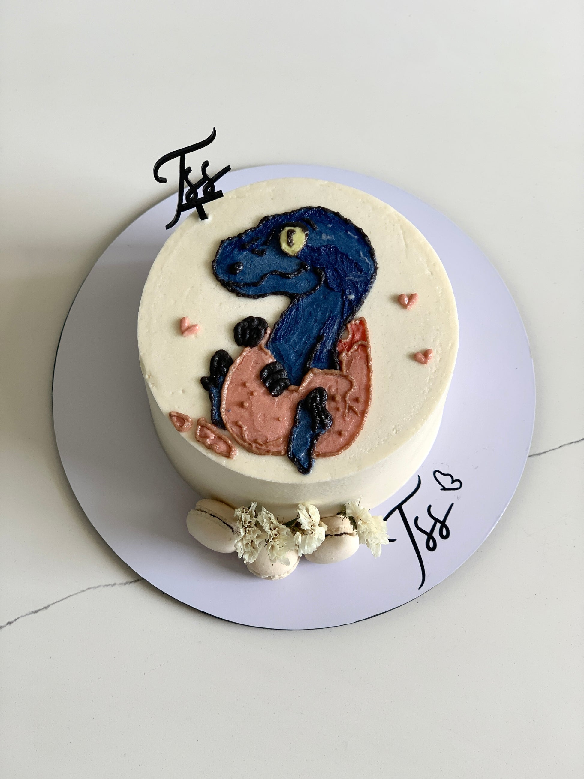 Buttercream illustration cake by The Sinful Spoon featuring colorful floral and whimsical designs on a layered cake.