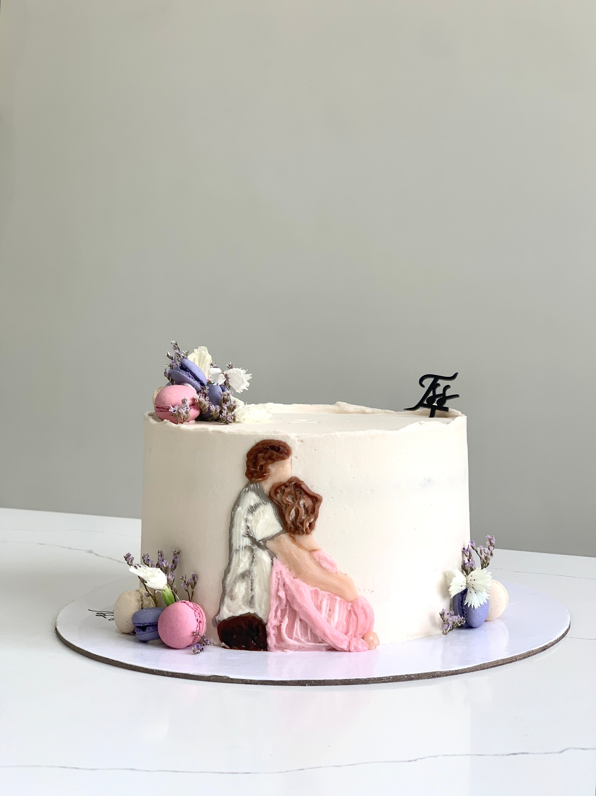 Decorative baby shower cake from The Sinful Spoon with pastel colors and baby-themed design, perfect for celebrating a new arrival.