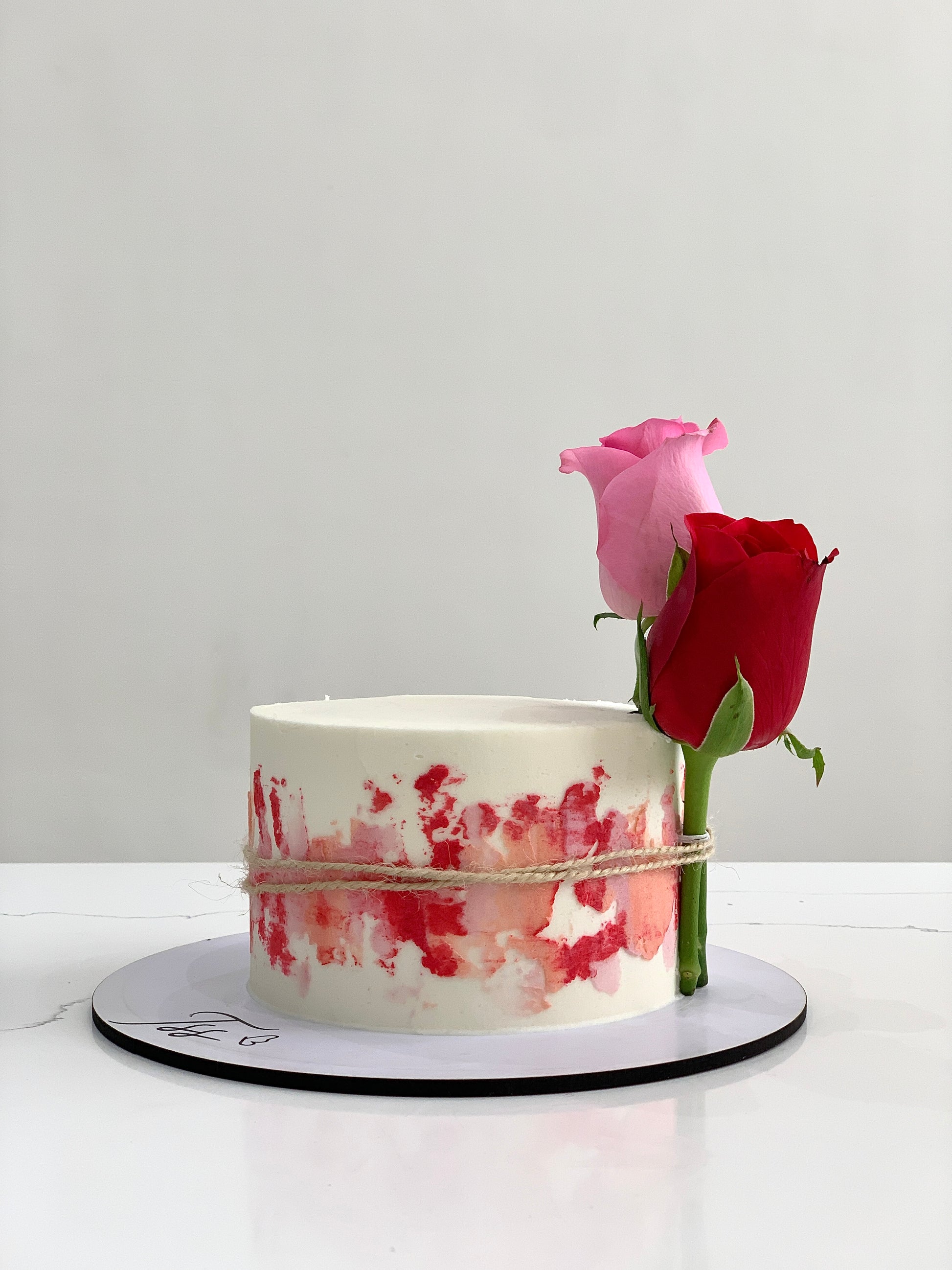 Fresh floral cakes from The Sinful Spoon with colorful, decorated icing and edible floral accents on a white plate.