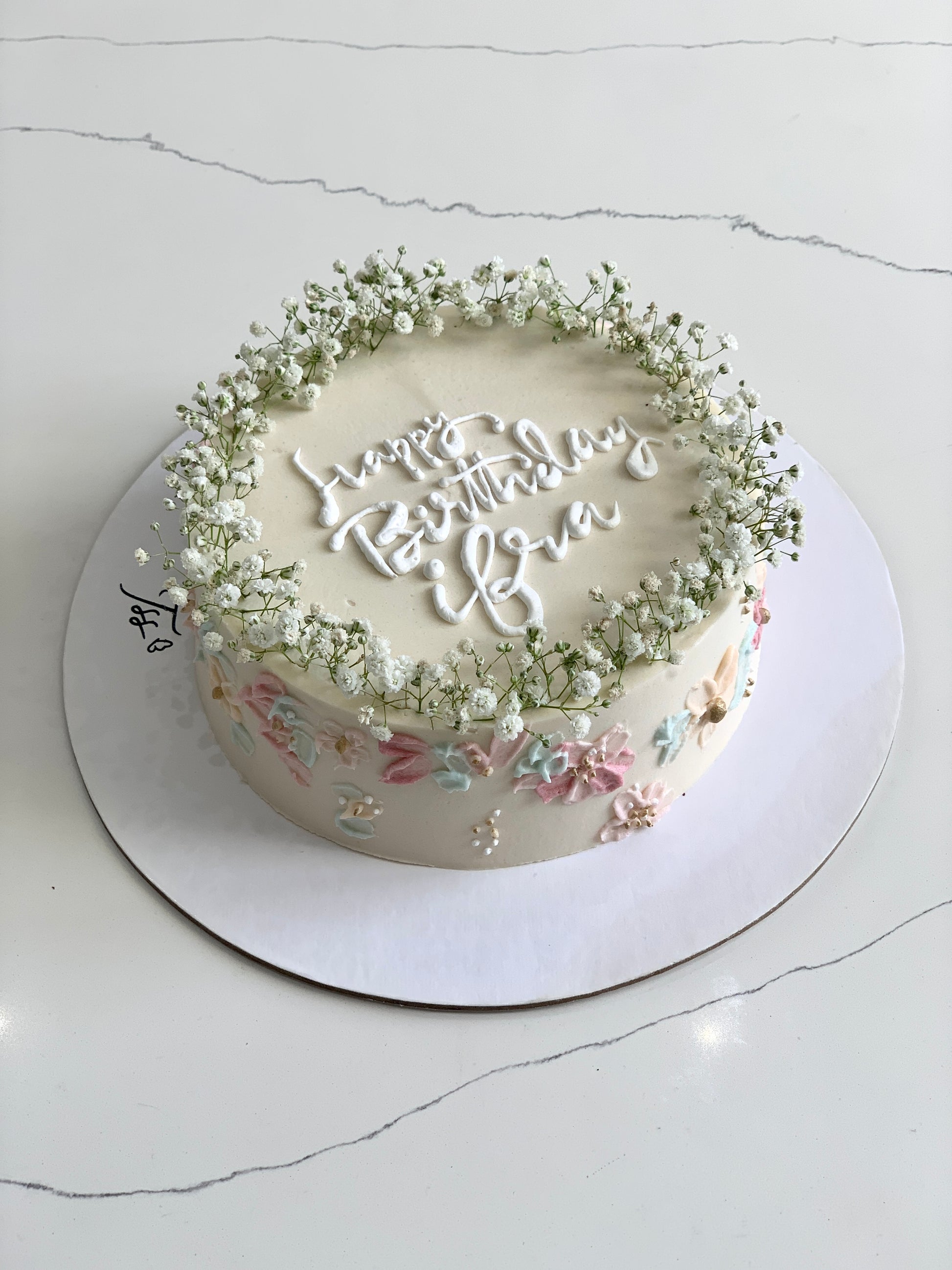 Colorful fresh floral cakes from The Sinful Spoon with vibrant icing and edible flowers, perfect for special celebrations.