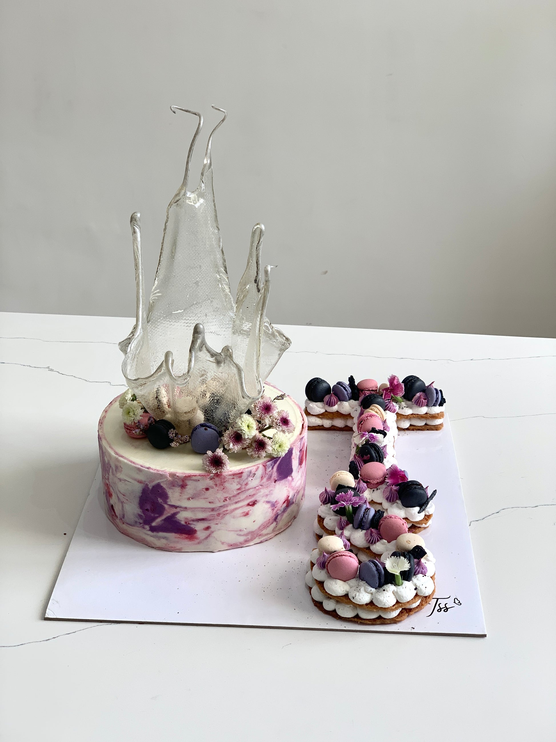 Assorted combo cakes from The Sinful Spoon featuring layered, decorated cakes on a dessert platter.