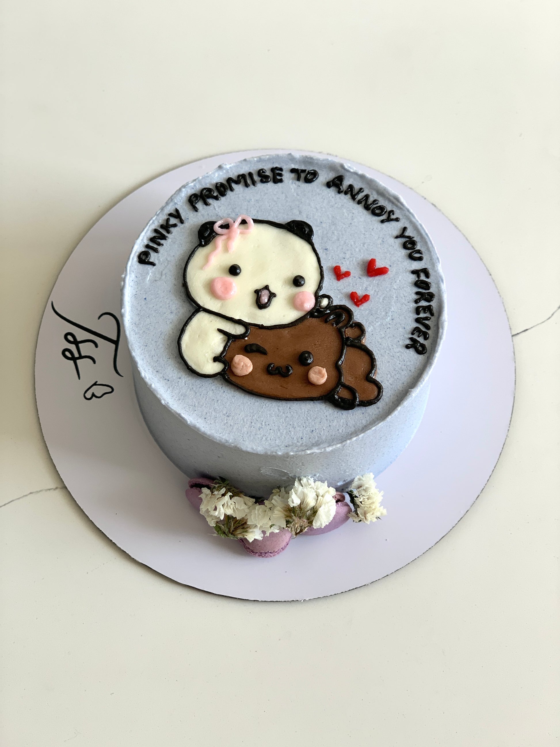 Decorative buttercream illustration cake by The Sinful Spoon featuring colorful, artistic frosting designs on a round cake.